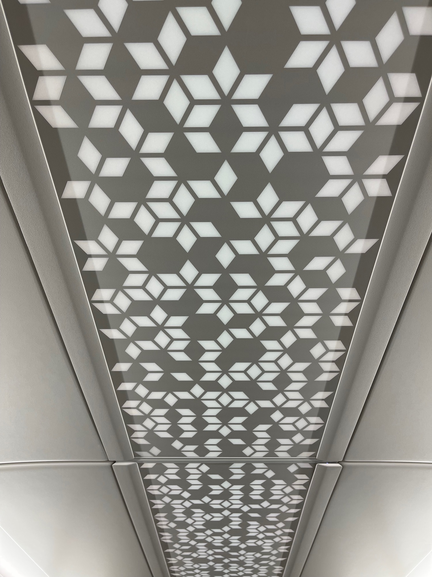 a grey and white ceiling with white squares