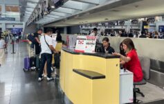 people at a counter in a airport