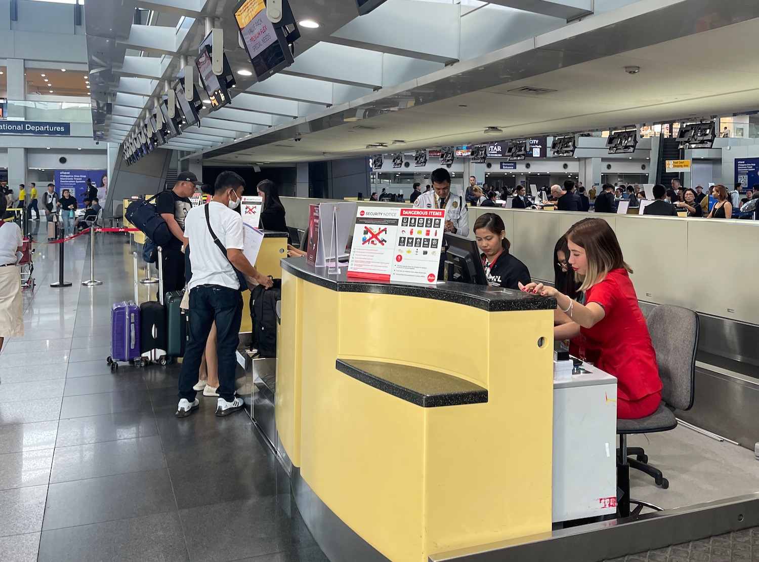 people at a counter in a airport