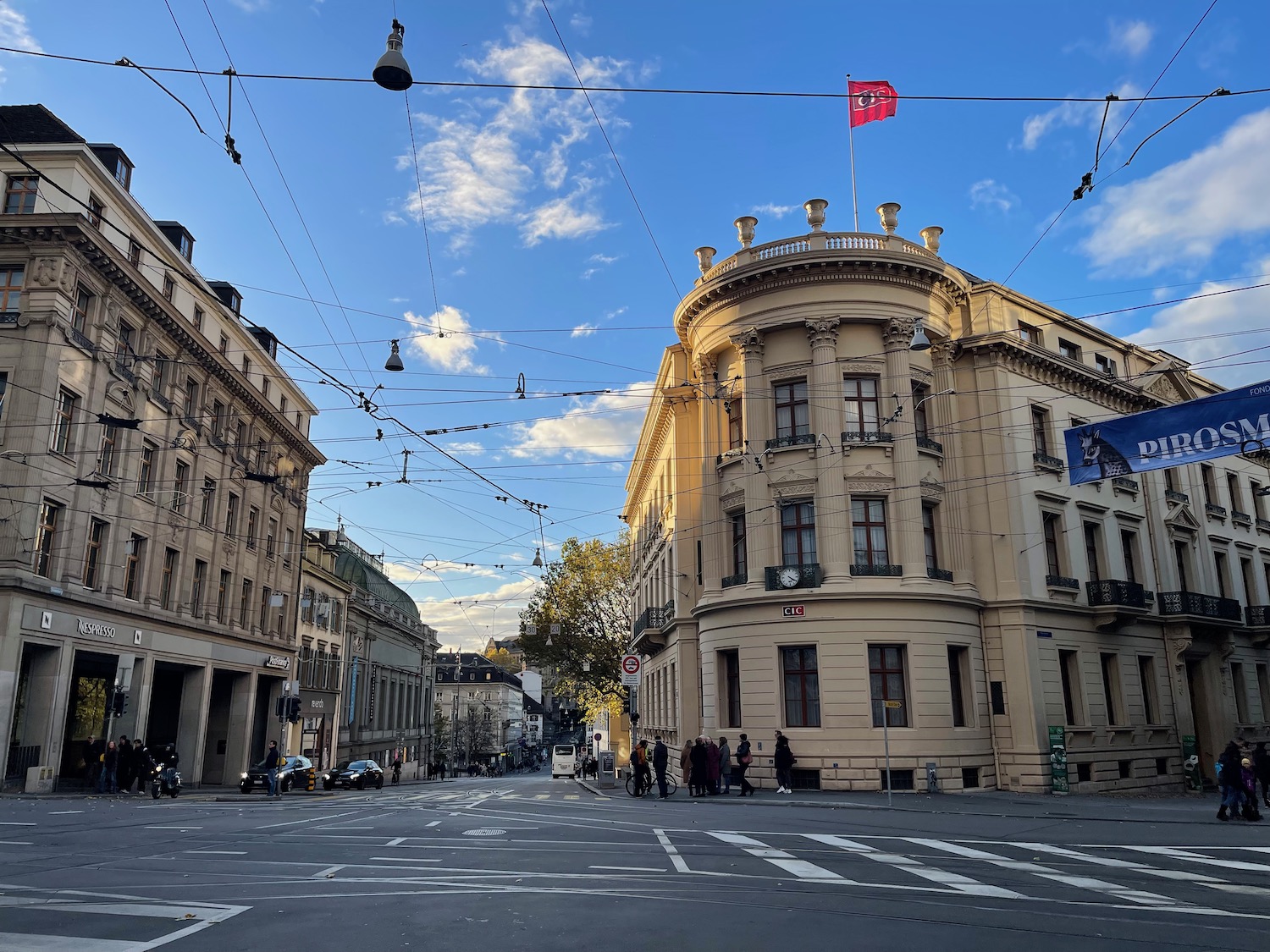 a street with a building and people walking on it