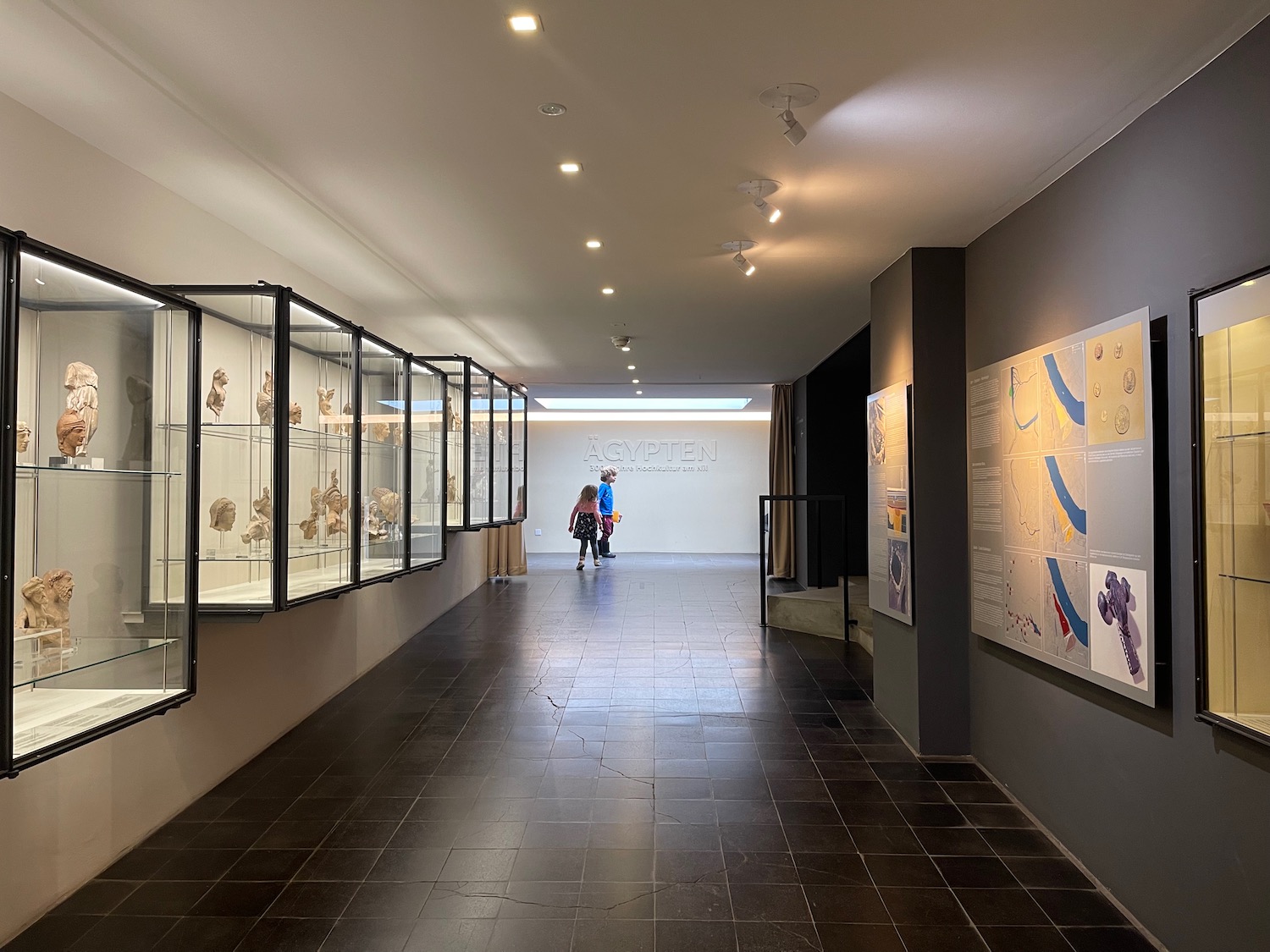 a hallway with a couple of people walking