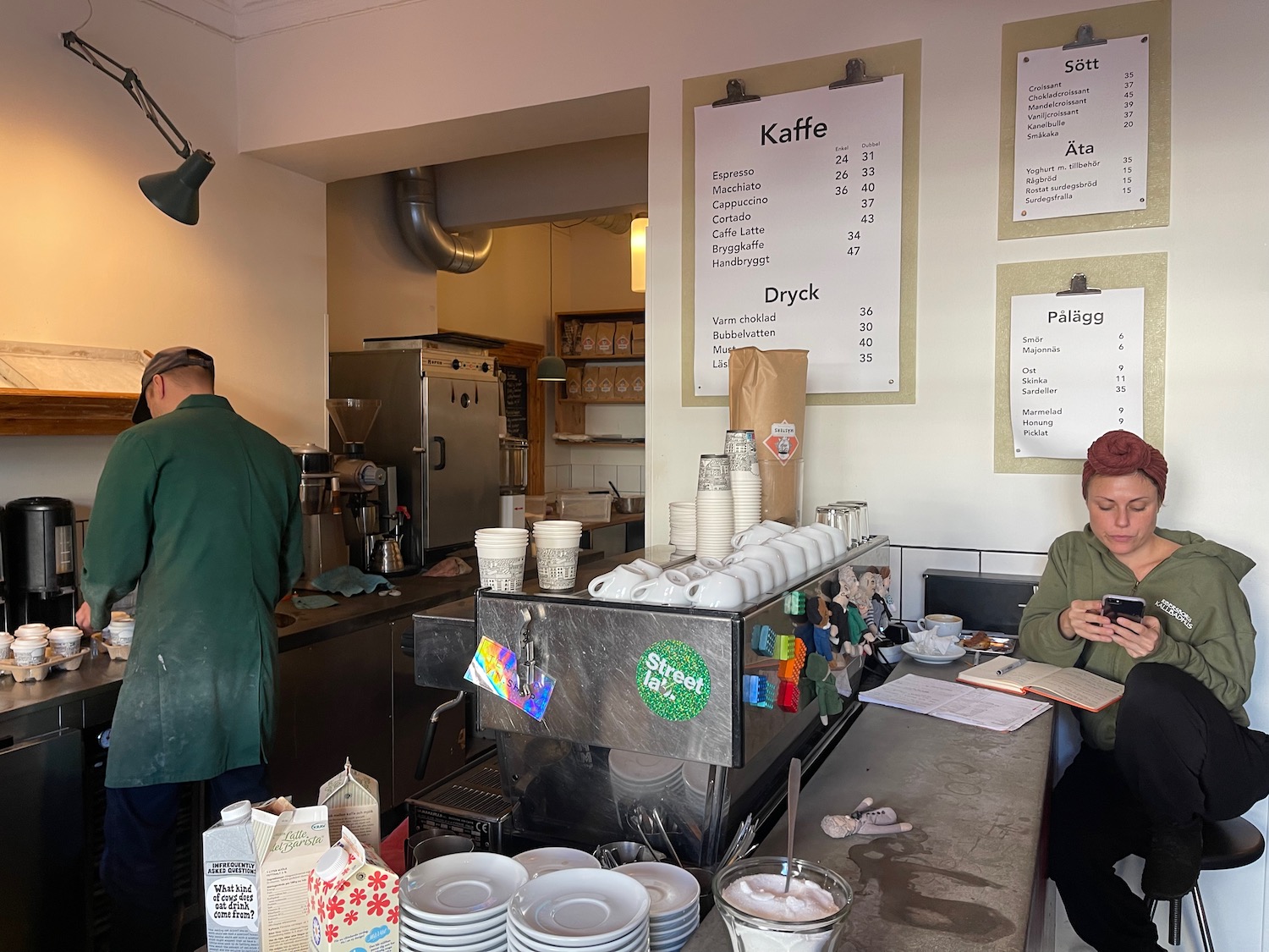 a woman sitting at a counter in a coffee shop