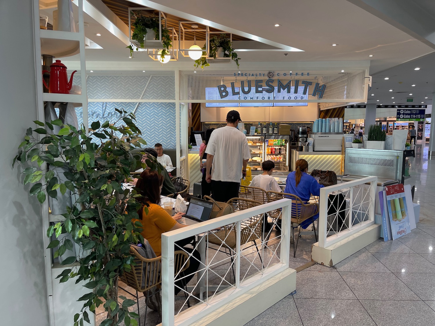 a group of people sitting at tables in a cafe