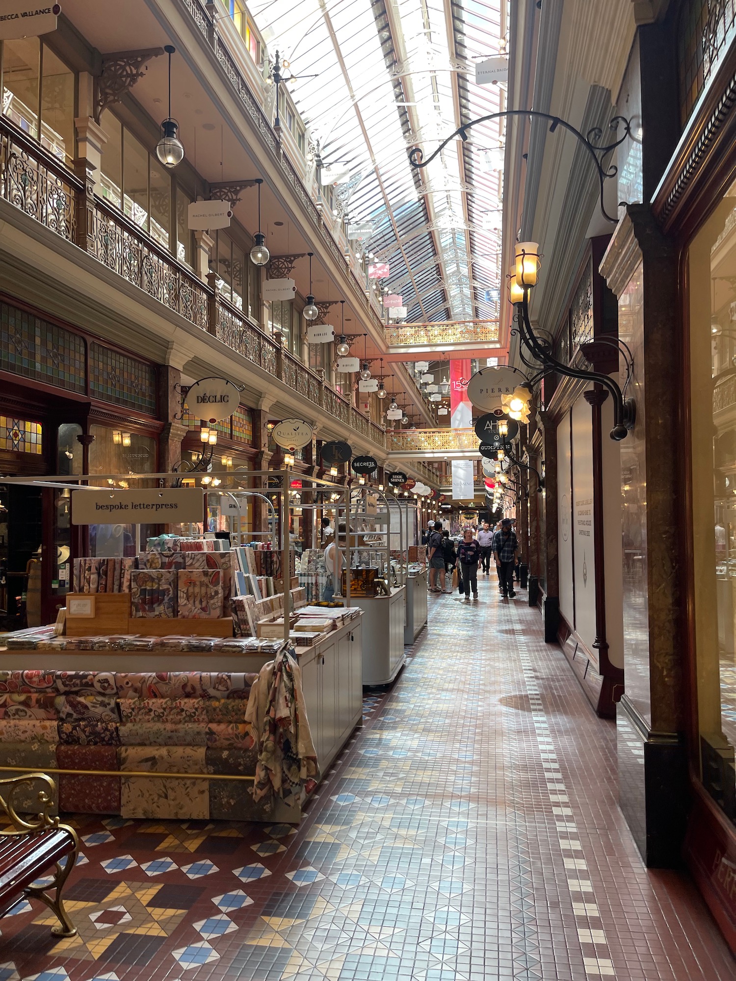 a large building with many shops and people walking