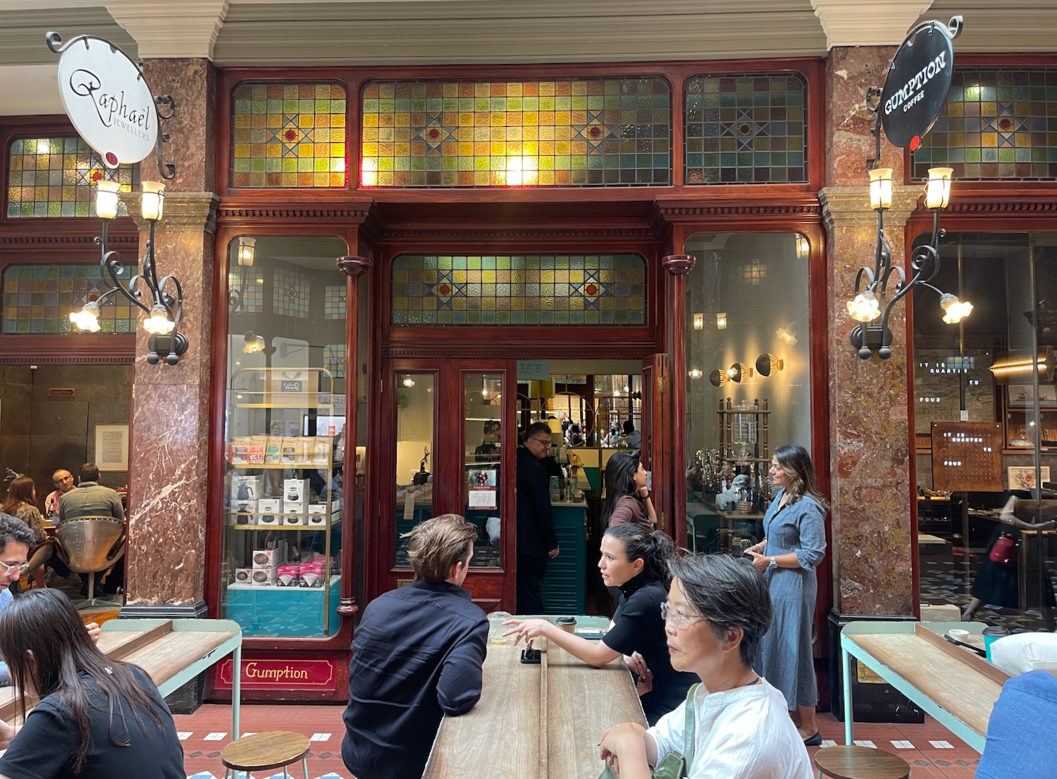 people sitting at tables in a building