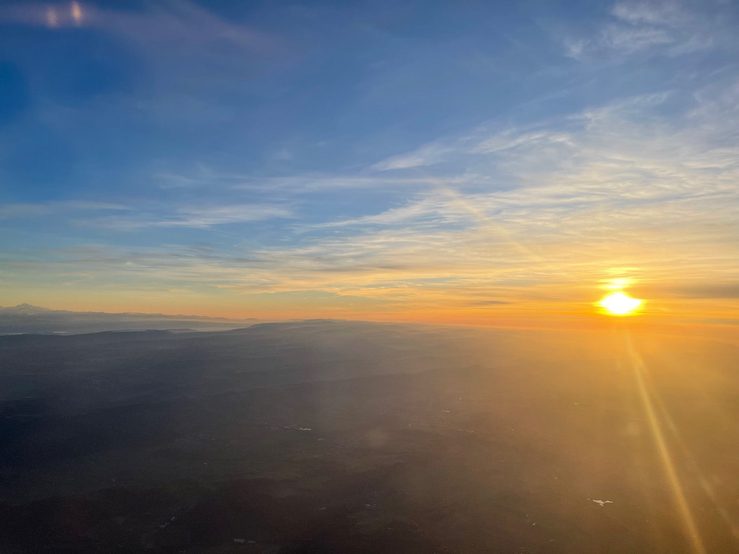 a sun setting over a landscape