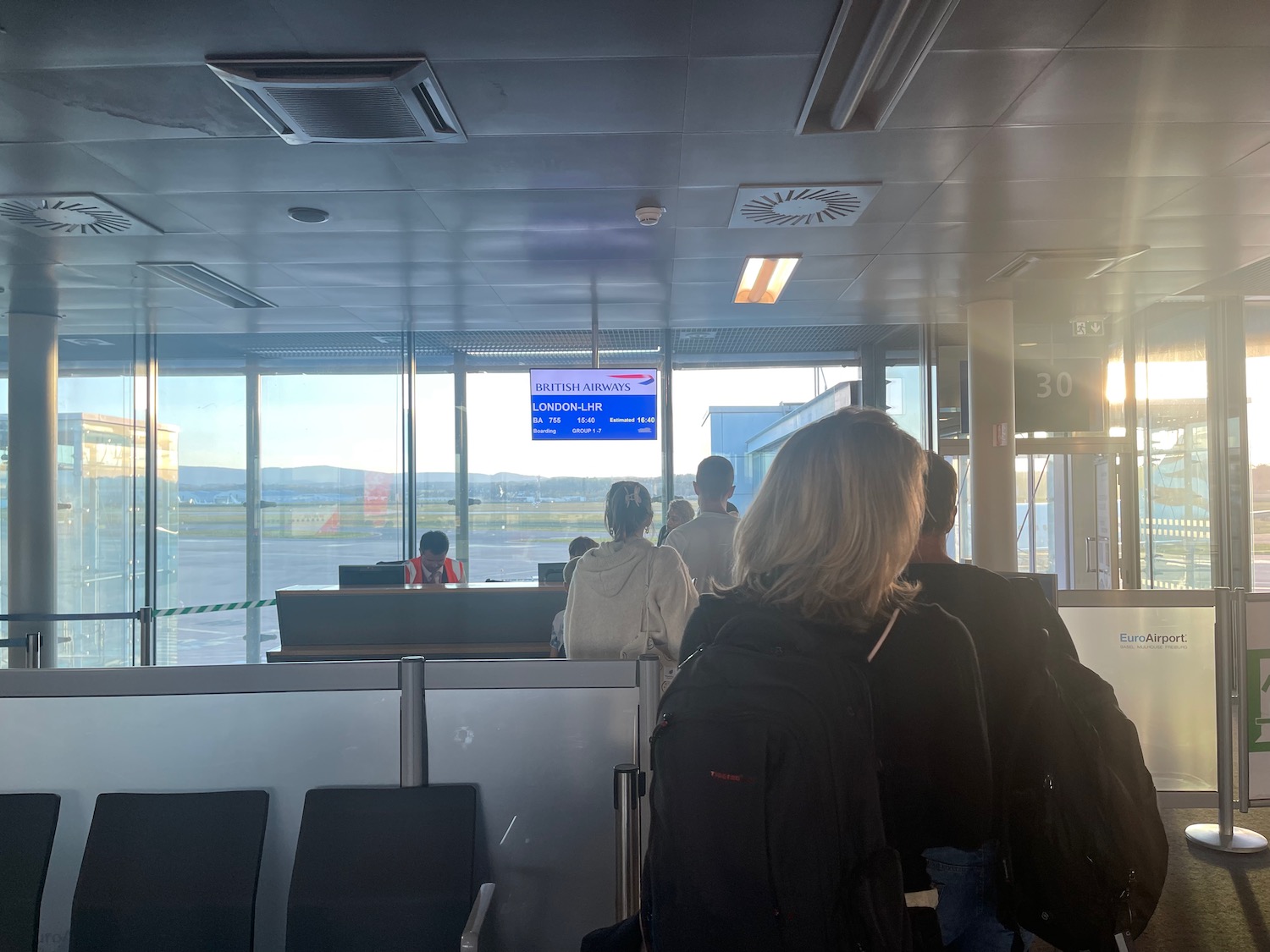 people standing in a line at an airport