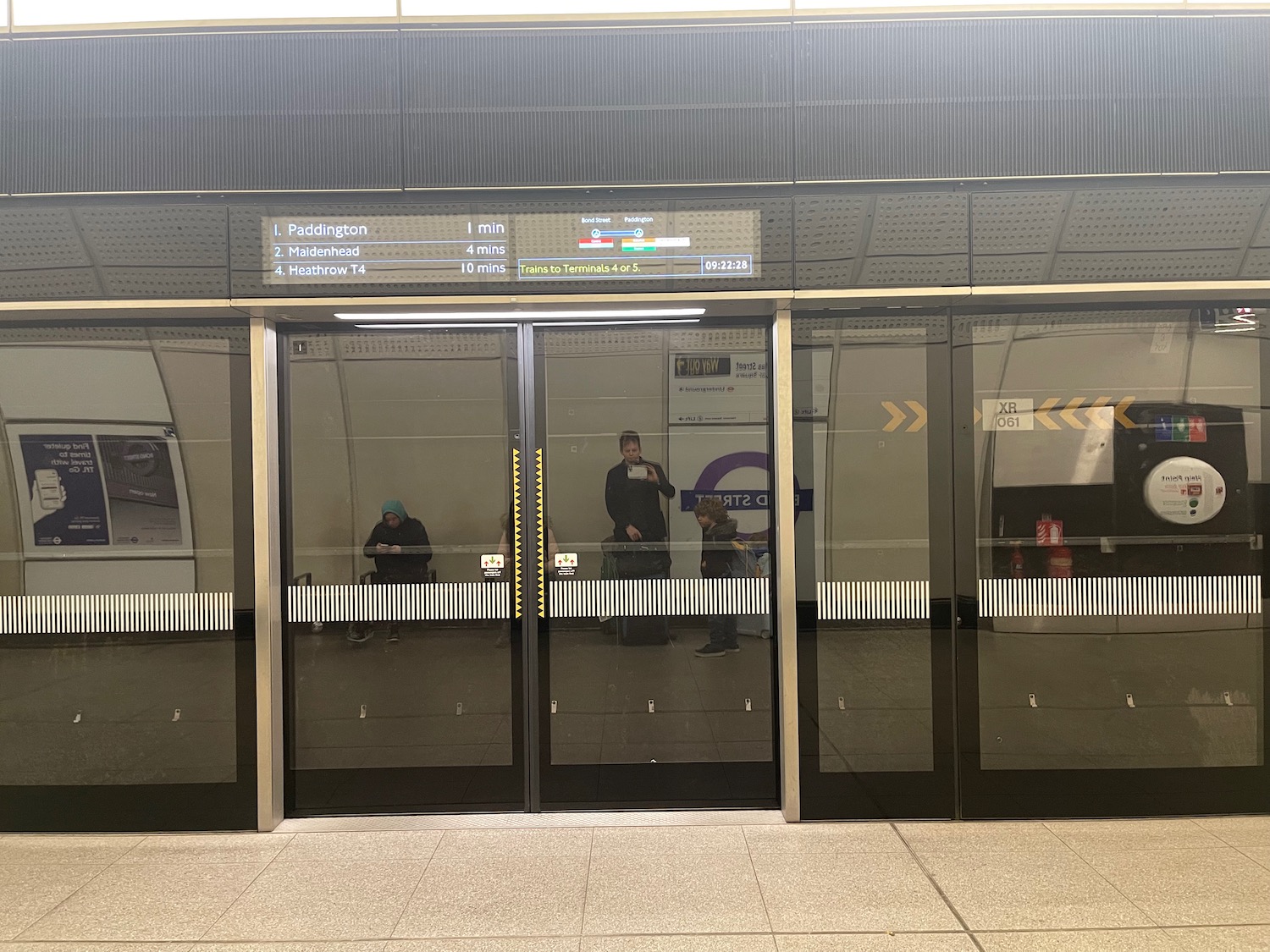 a glass doors with people standing in front of them