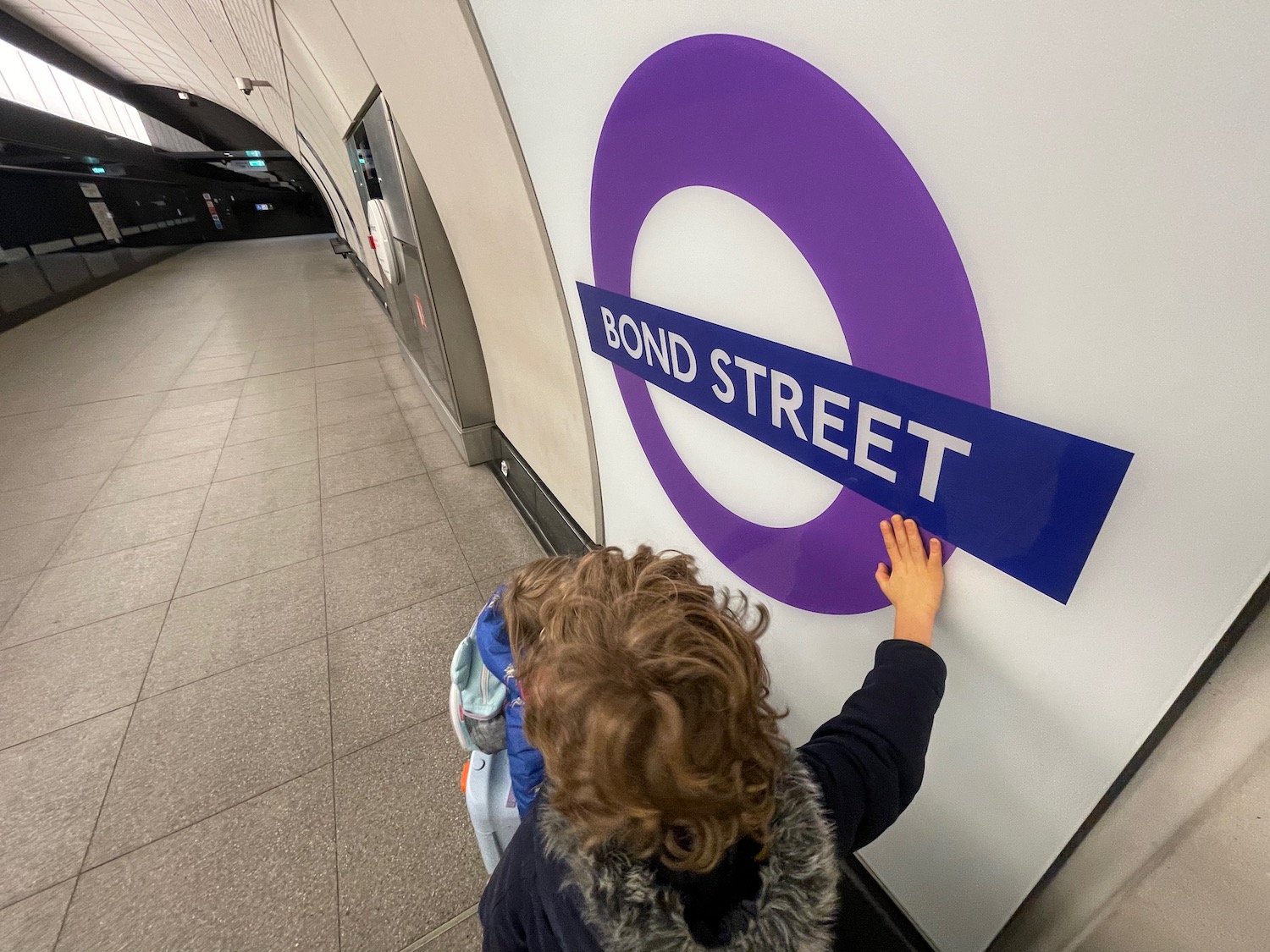 a child touching a sign