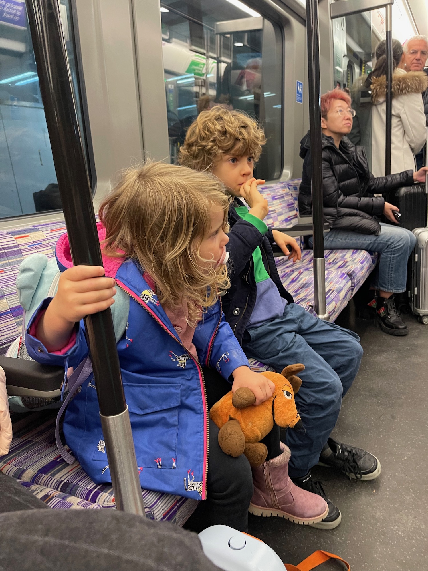 a group of kids sitting on a train