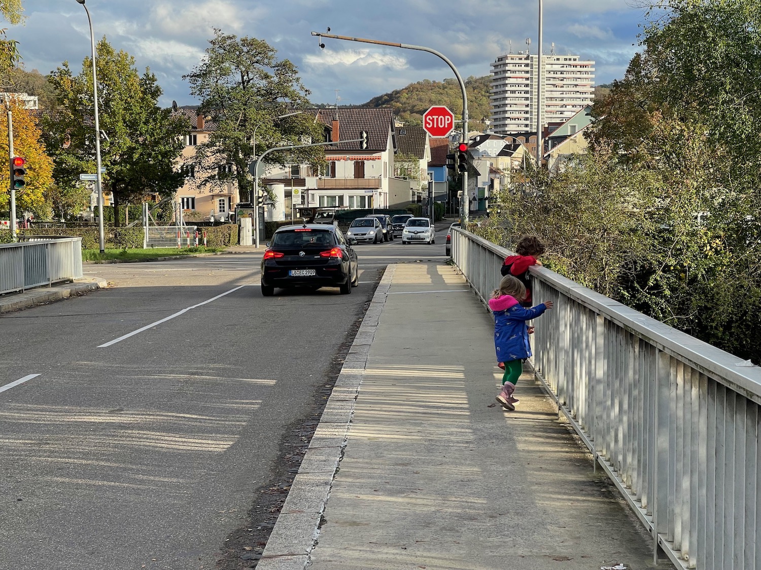 two children climbing a railing on a bridge