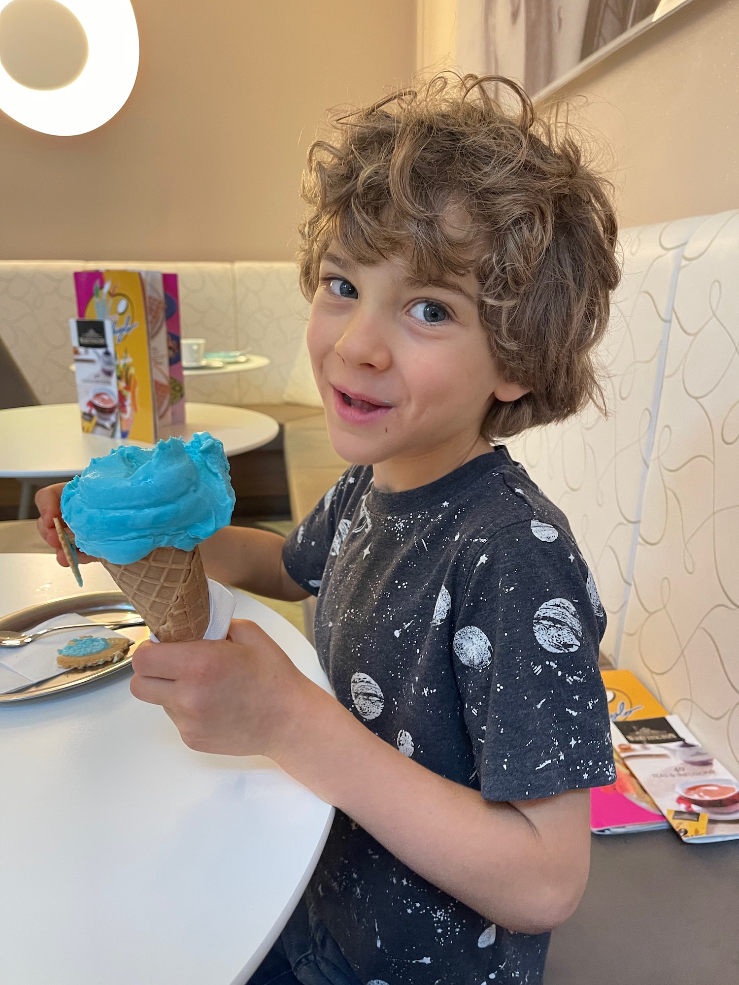 a boy holding an ice cream cone