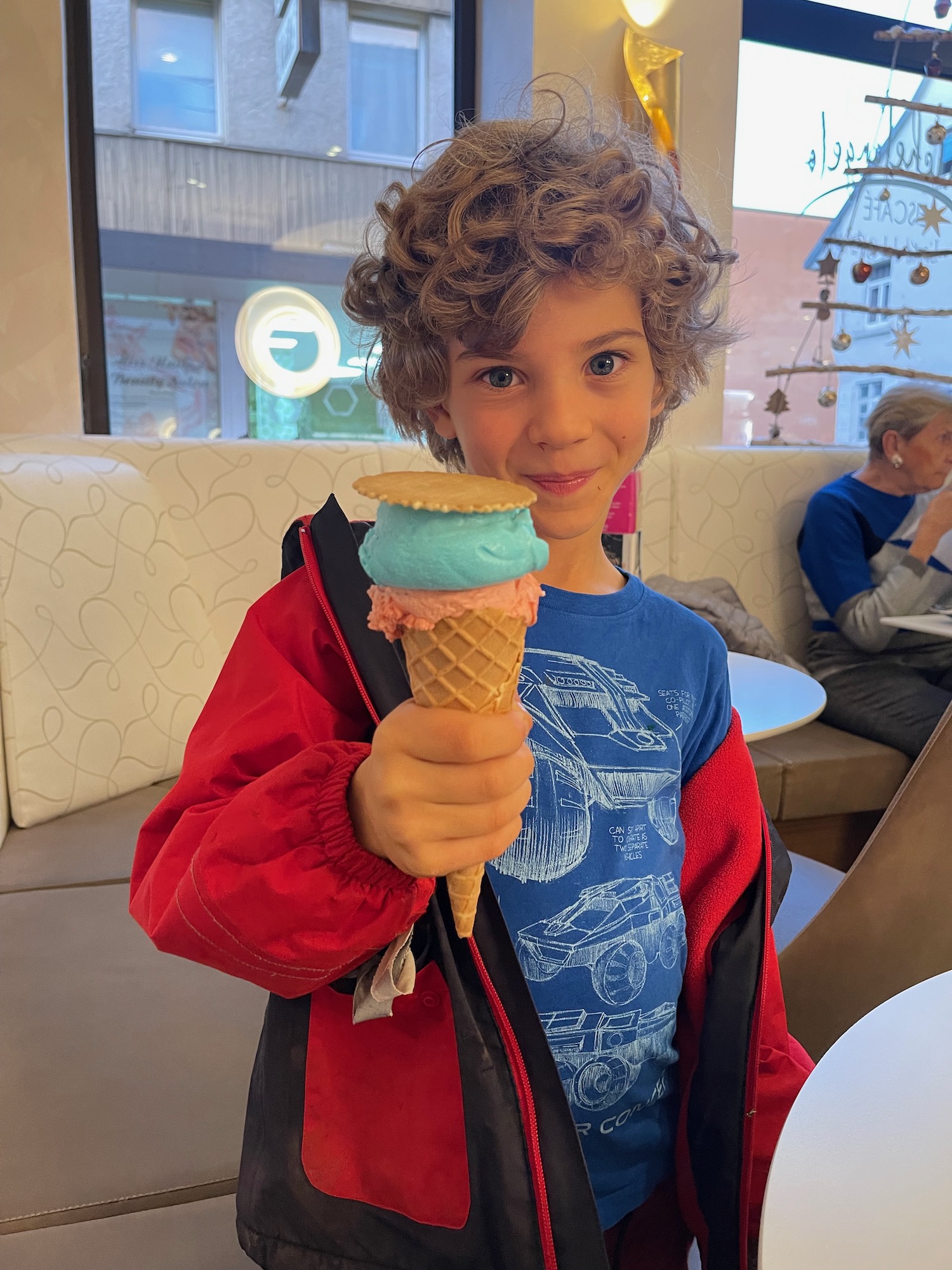 a child holding an ice cream cone