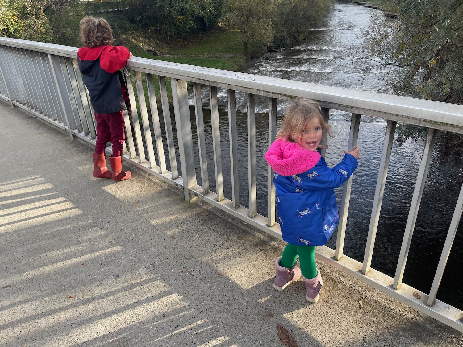 a group of children standing on a bridge