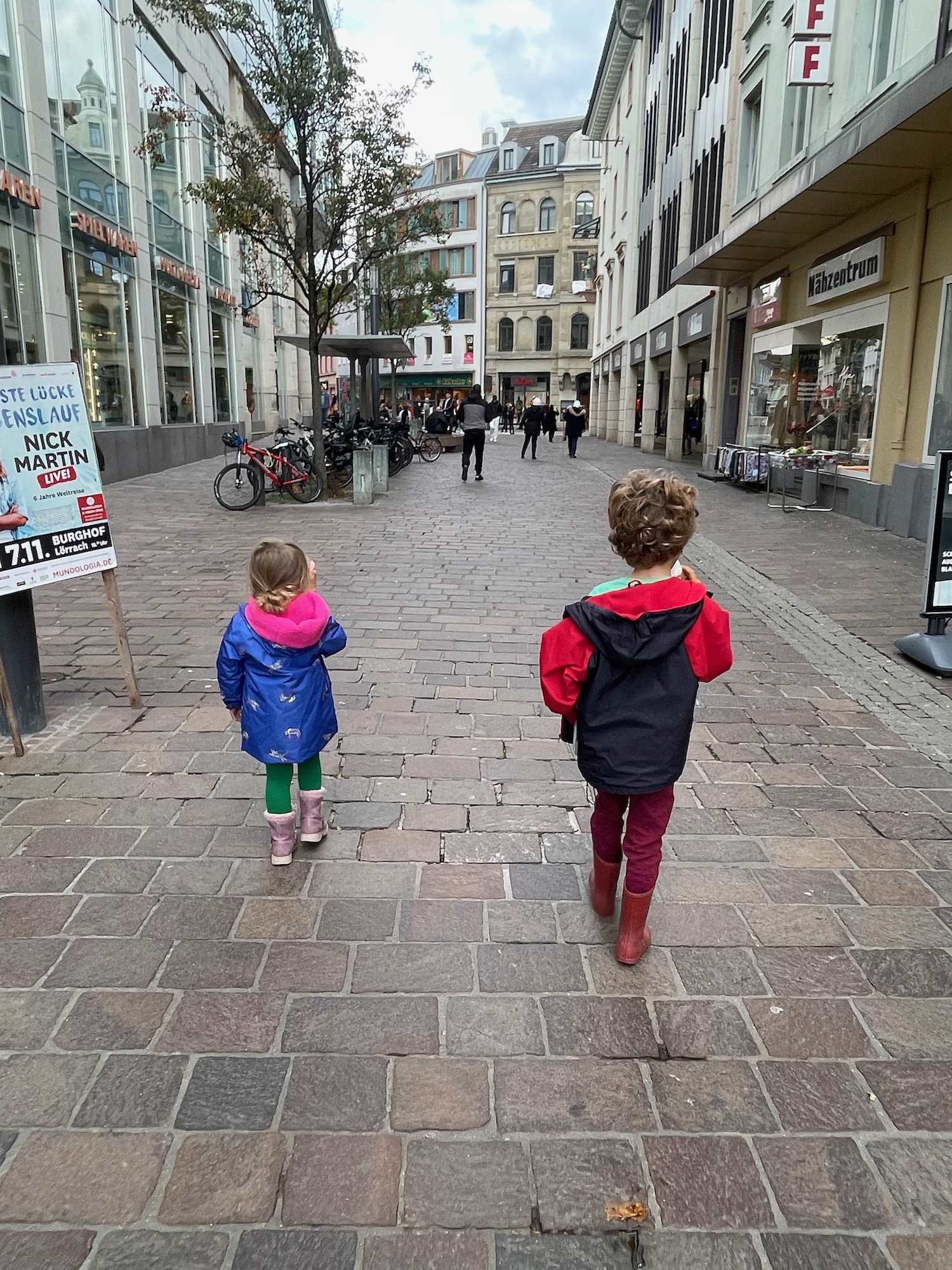 two children walking down a street