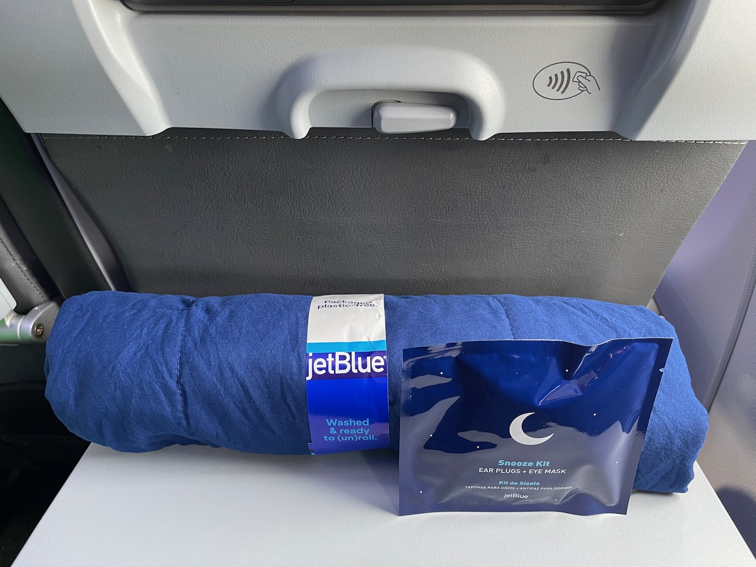 a blue blanket and a blue package on a seat