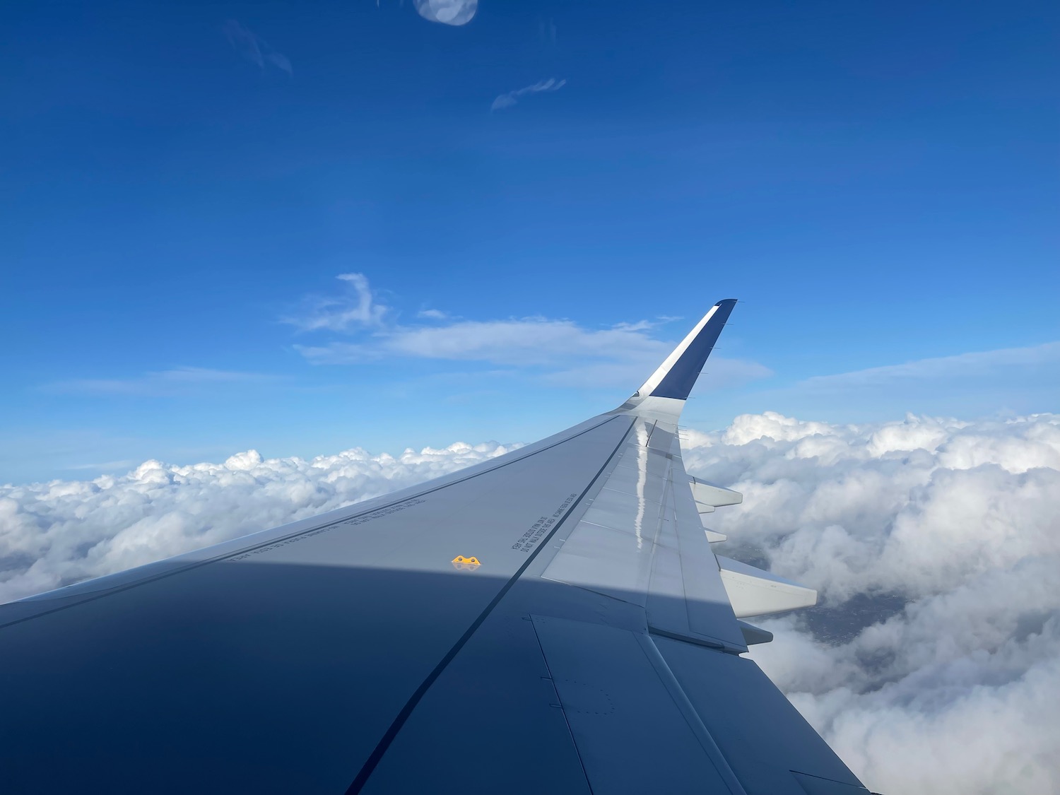 the wing of an airplane above the clouds