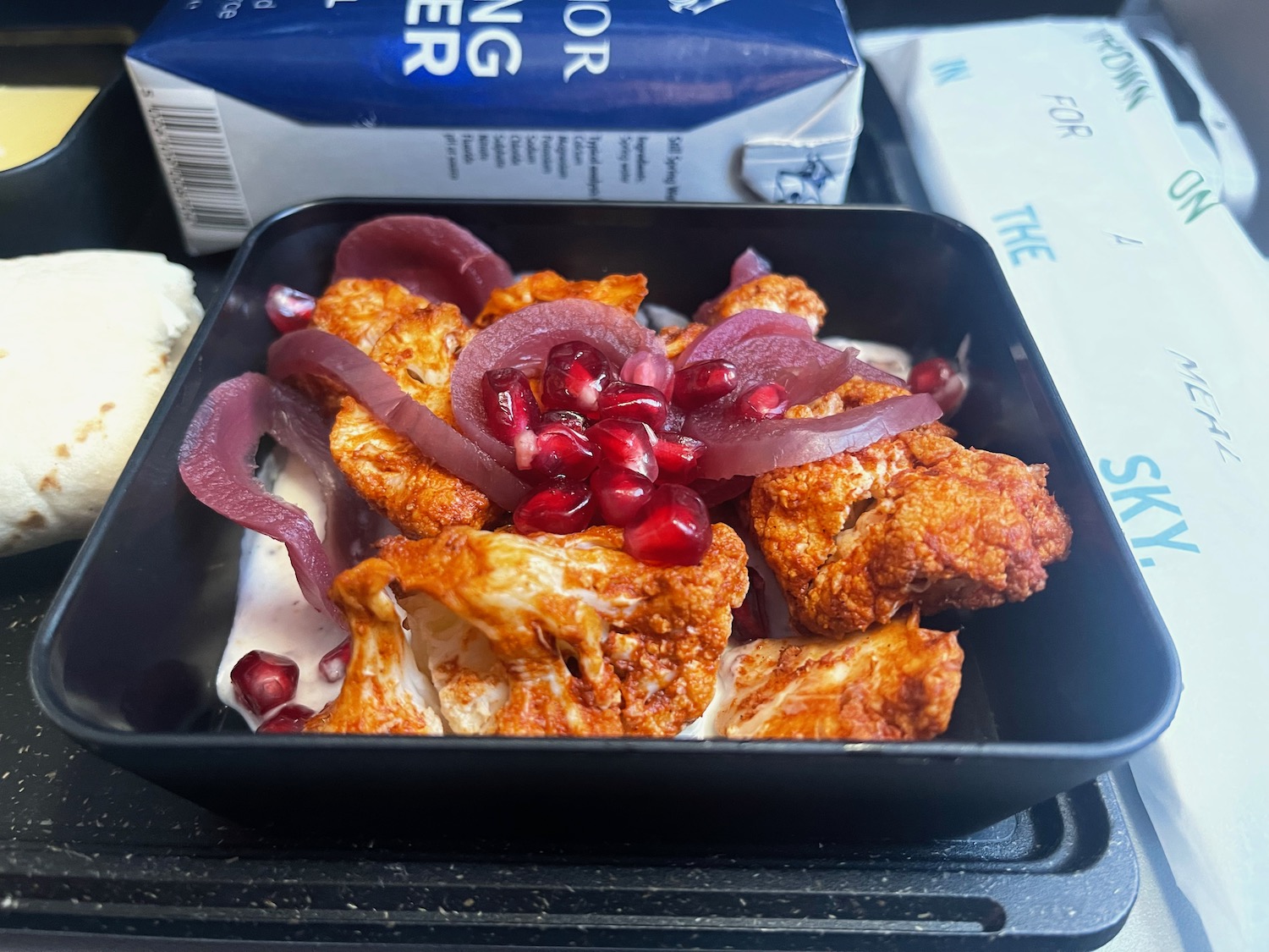 a bowl of food on a black surface