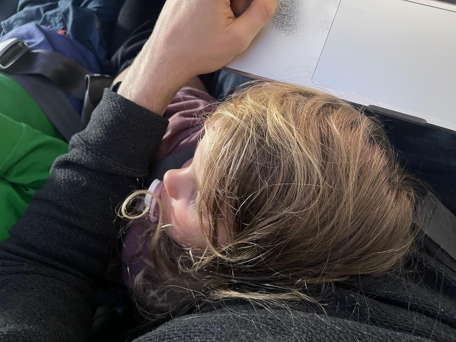 a person lying down with a book on their head