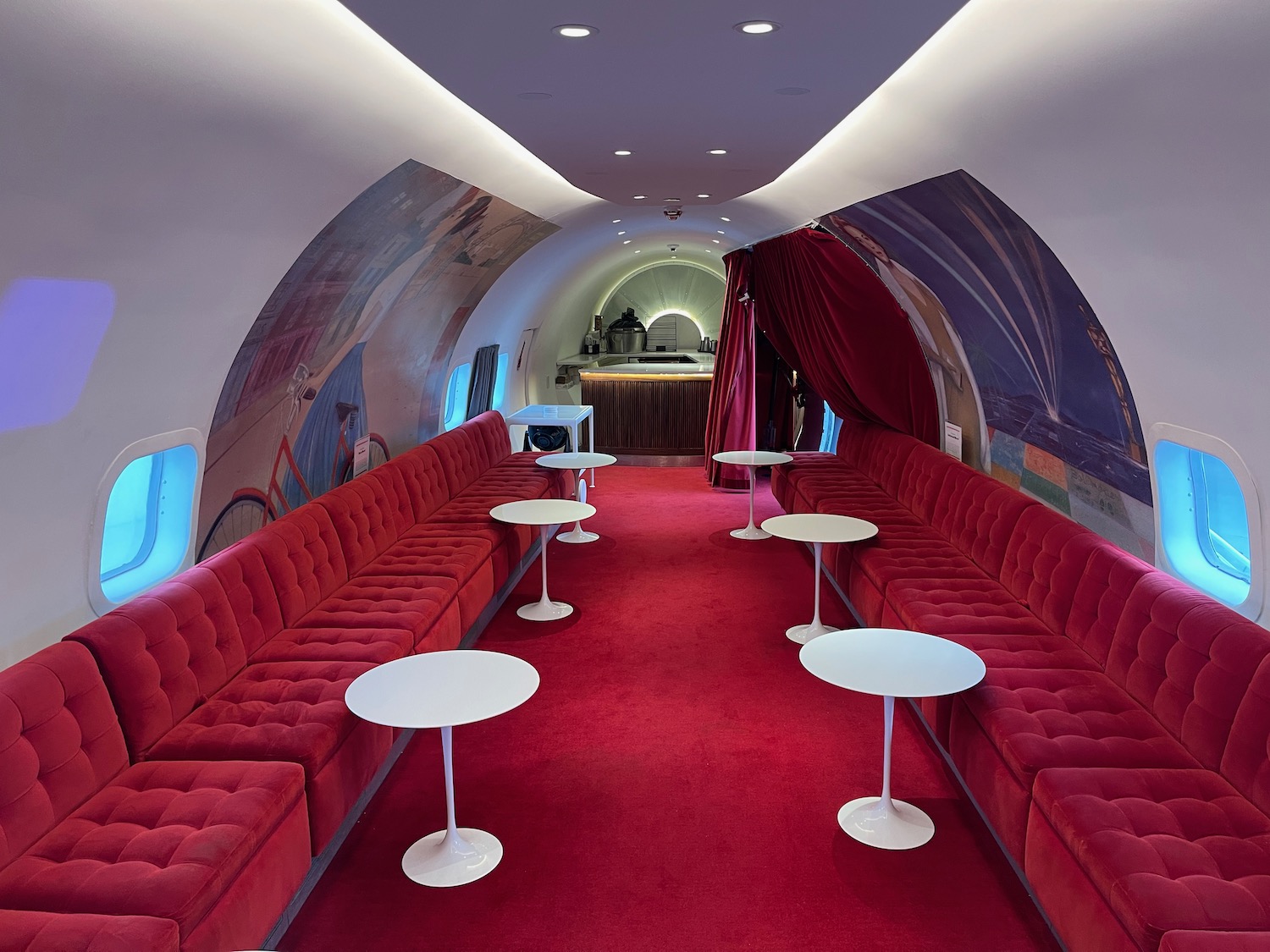 a red couches and tables in a plane