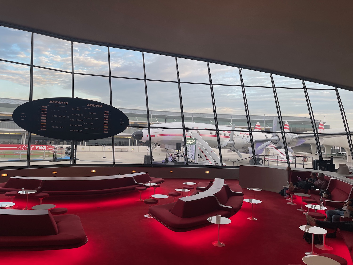 a large window with red lights and red couches