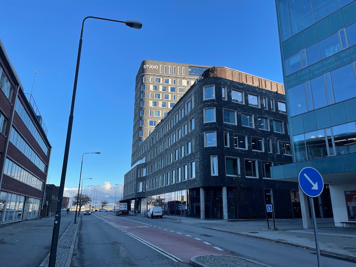 a street with a building and cars on it