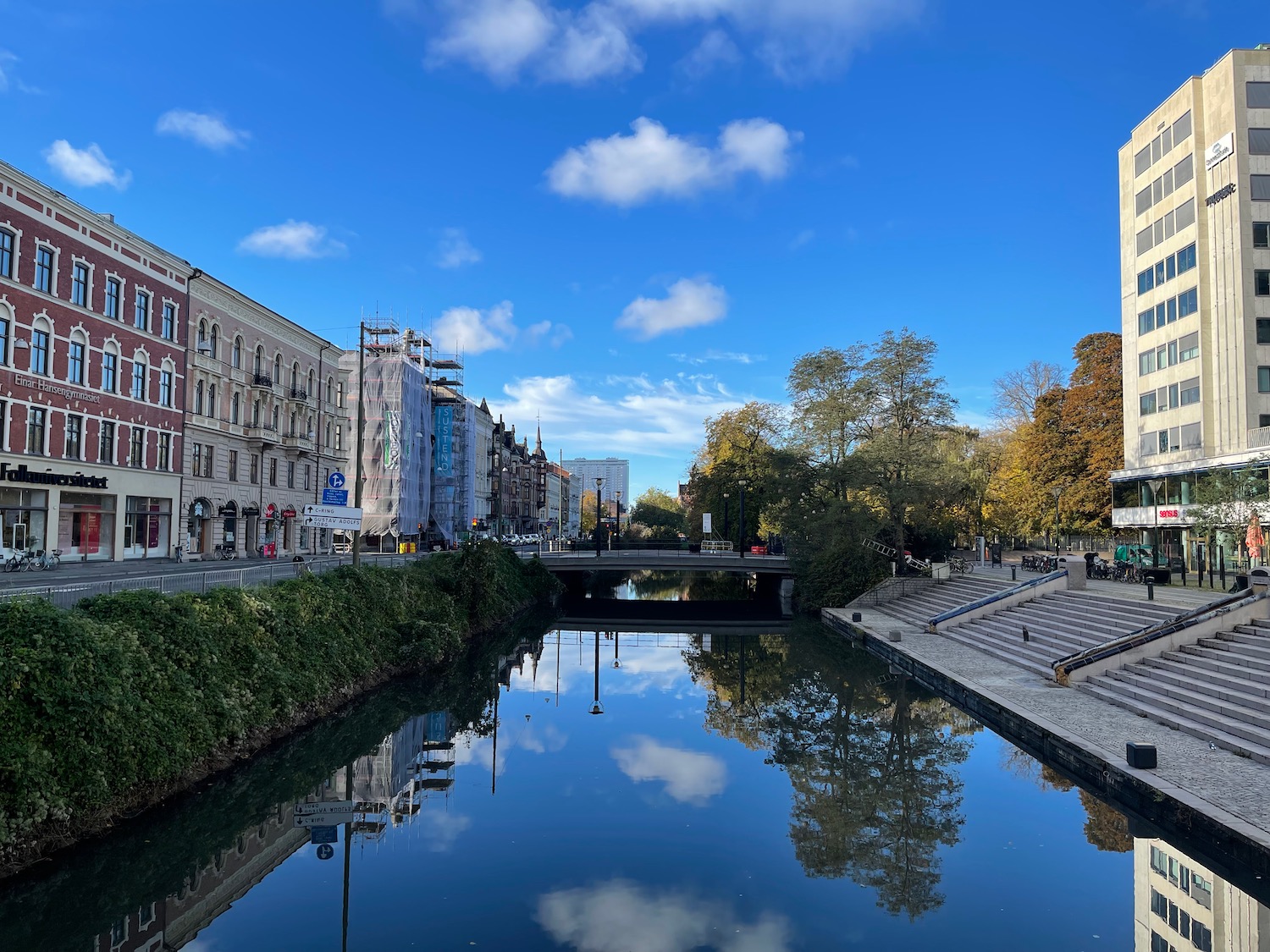 a river with buildings and stairs