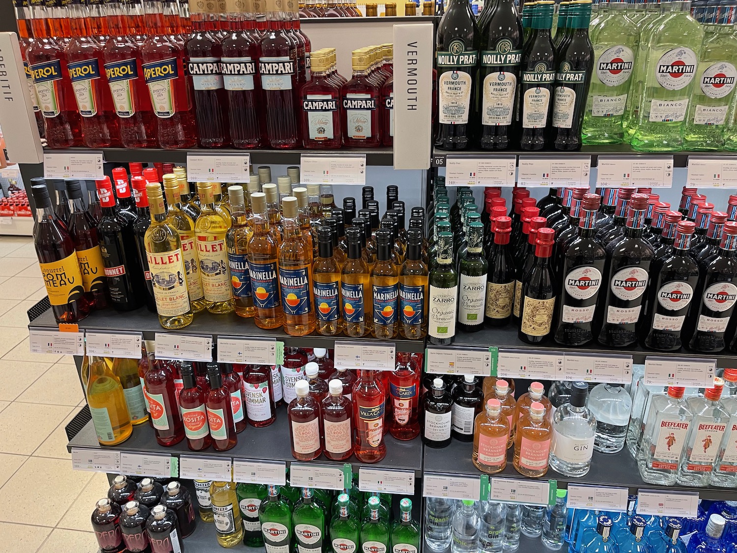 a shelf with bottles of alcohol