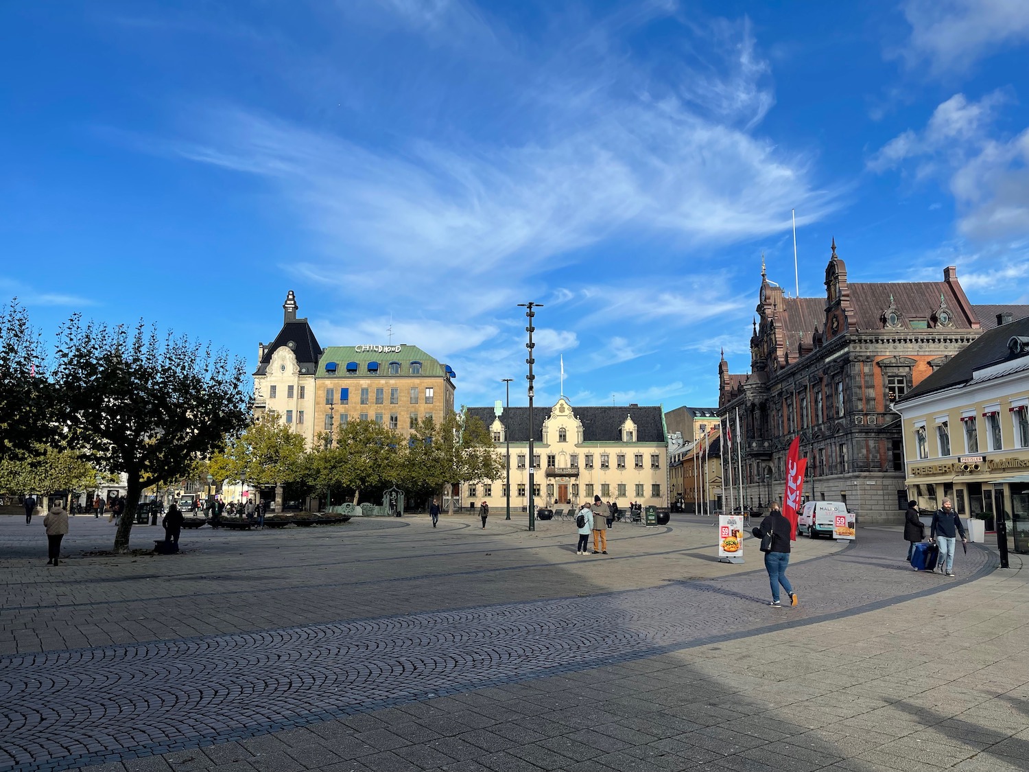 a group of people walking in a plaza