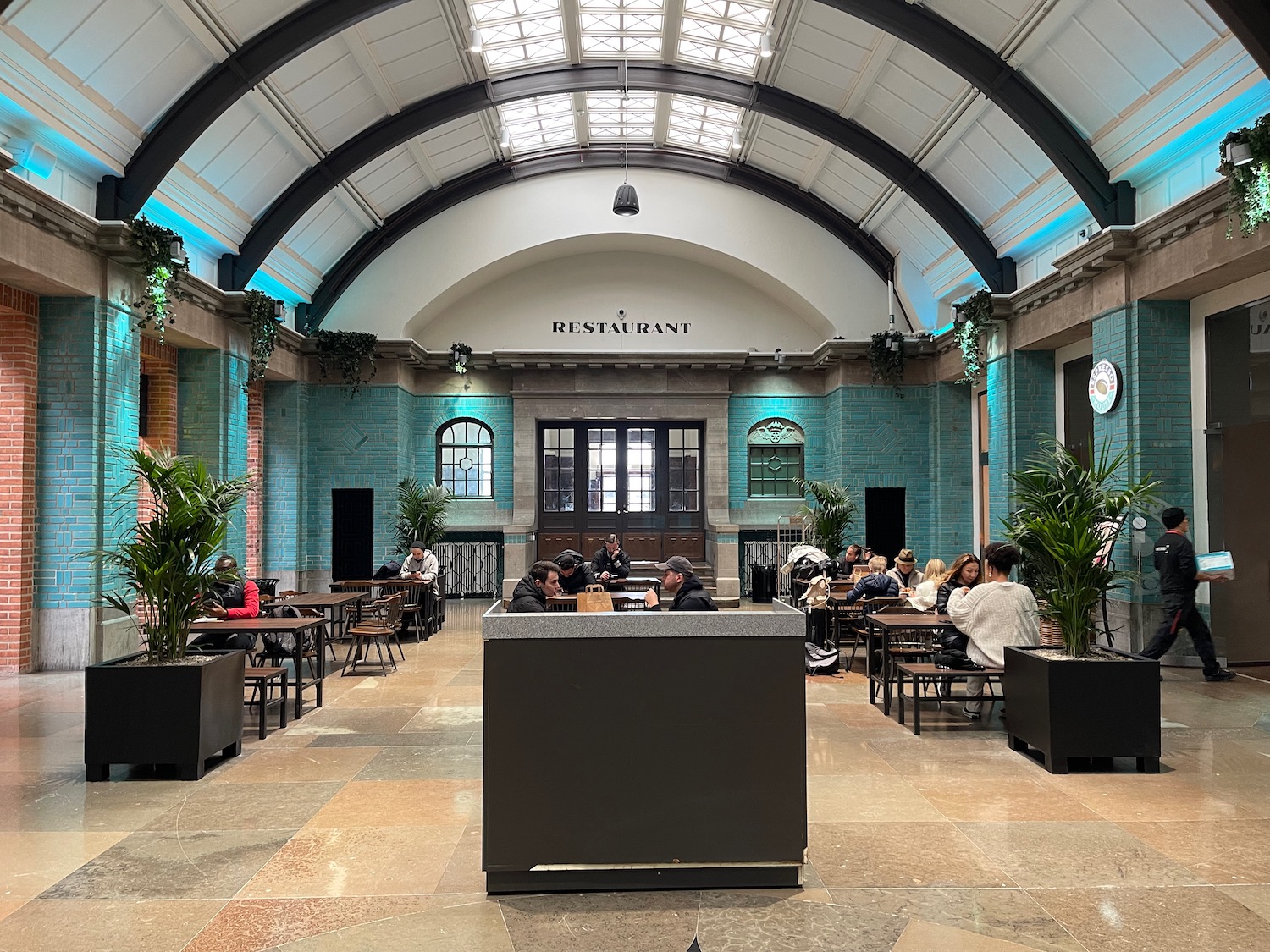 a group of people sitting at tables in a building