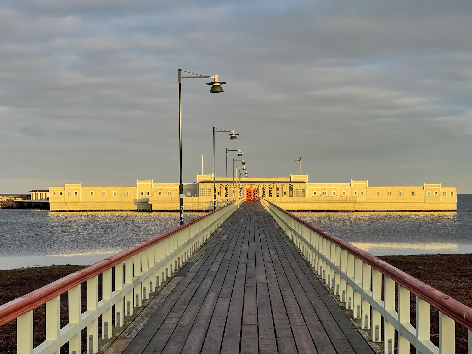 a long wooden walkway leading to a body of water