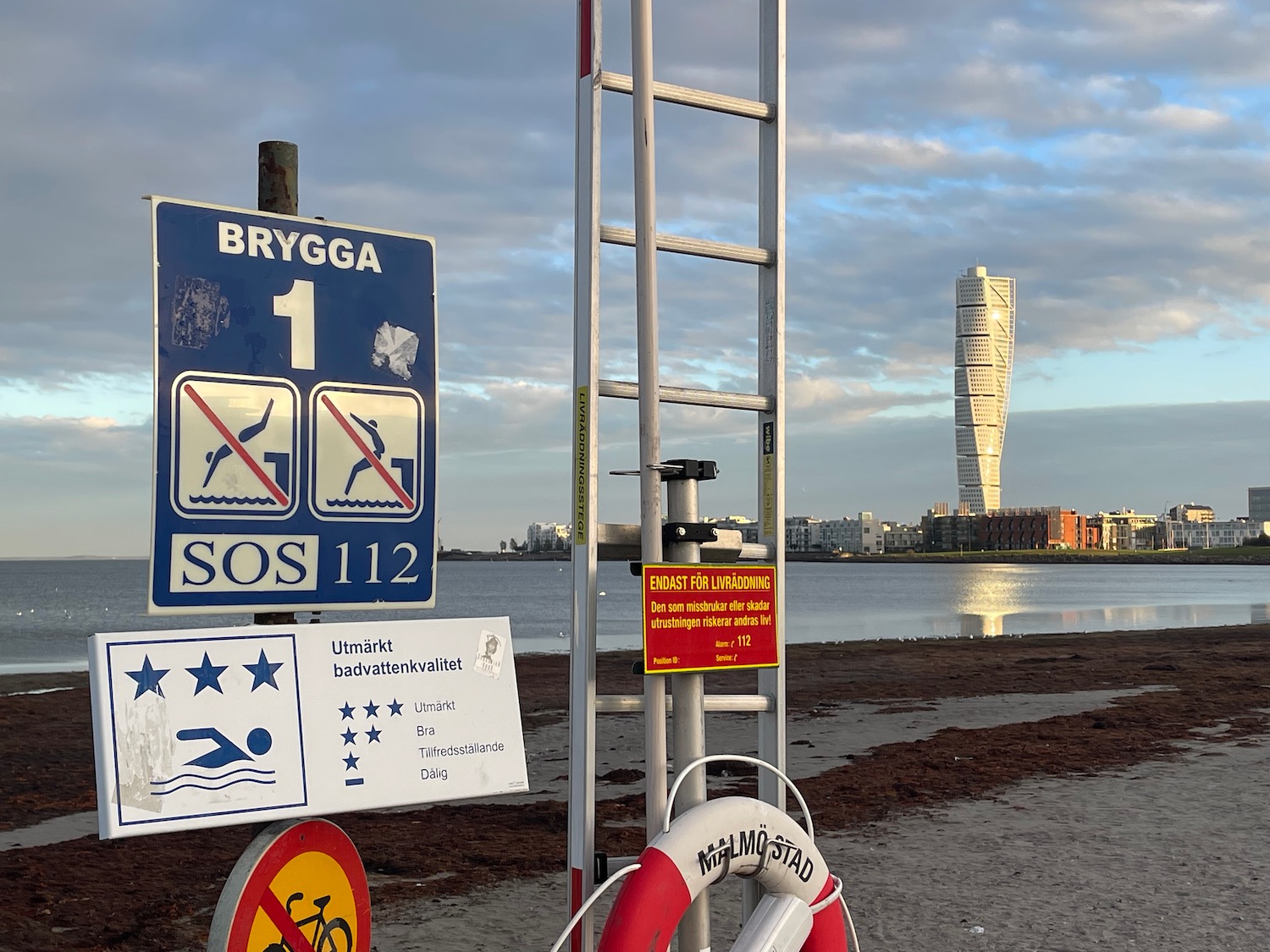 a ladder and a sign on a beach