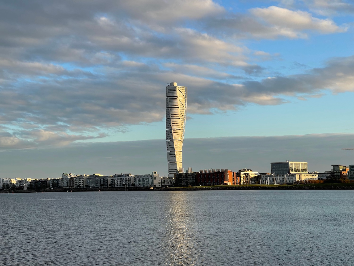 a tall building next to a body of water