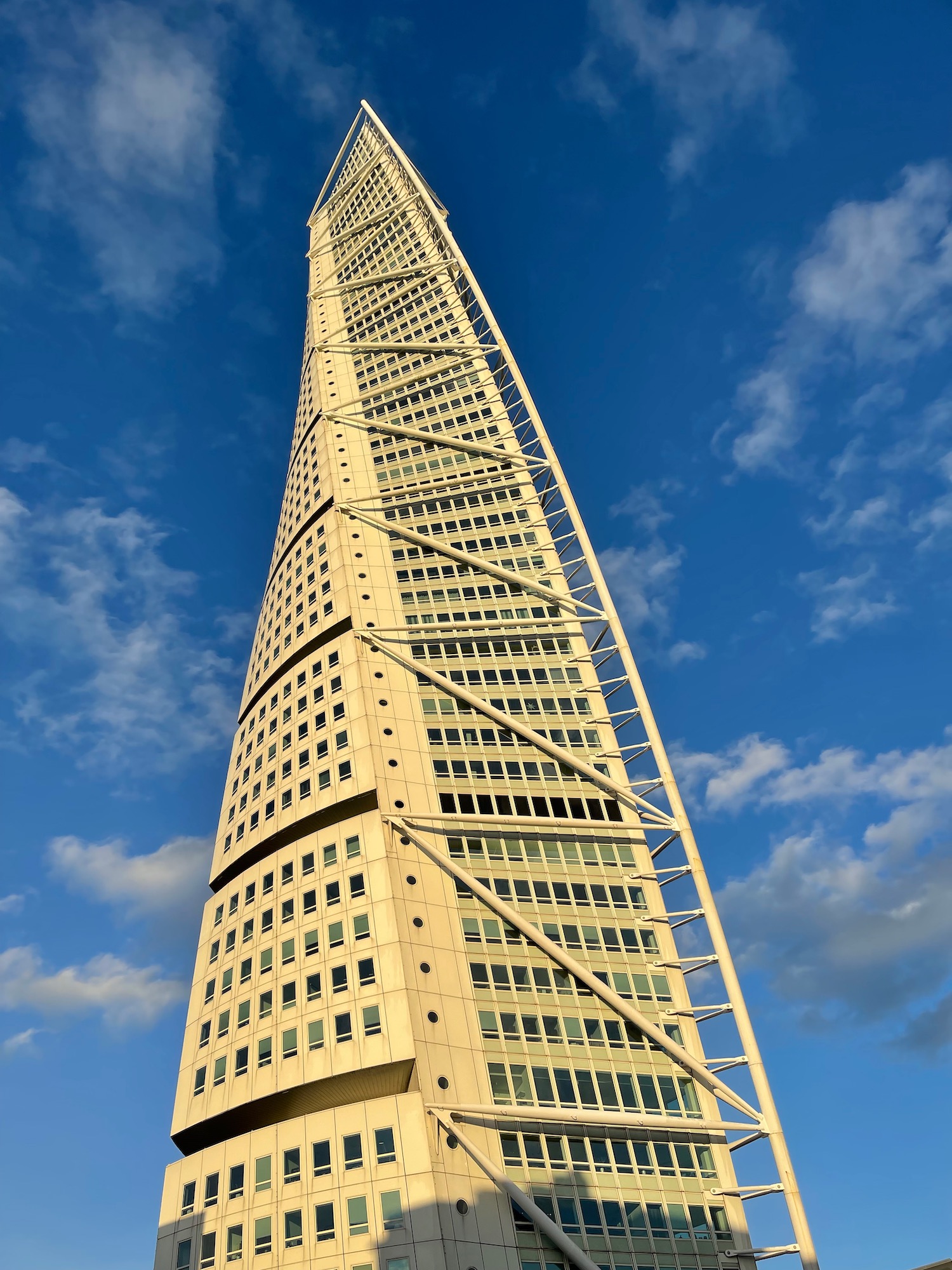 a tall building with many windows with Turning Torso in the background