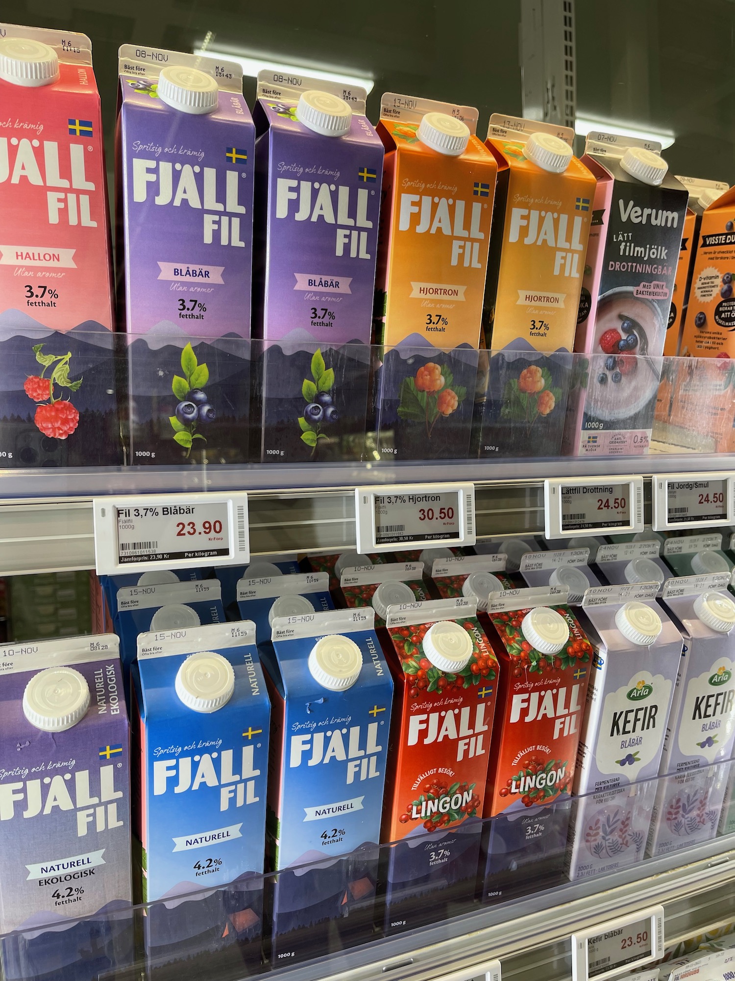 a shelf with cartons of juice