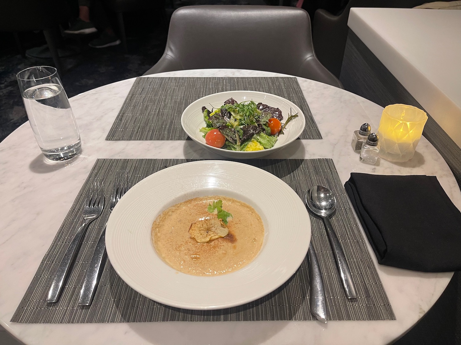 a plate of soup and salad on a table