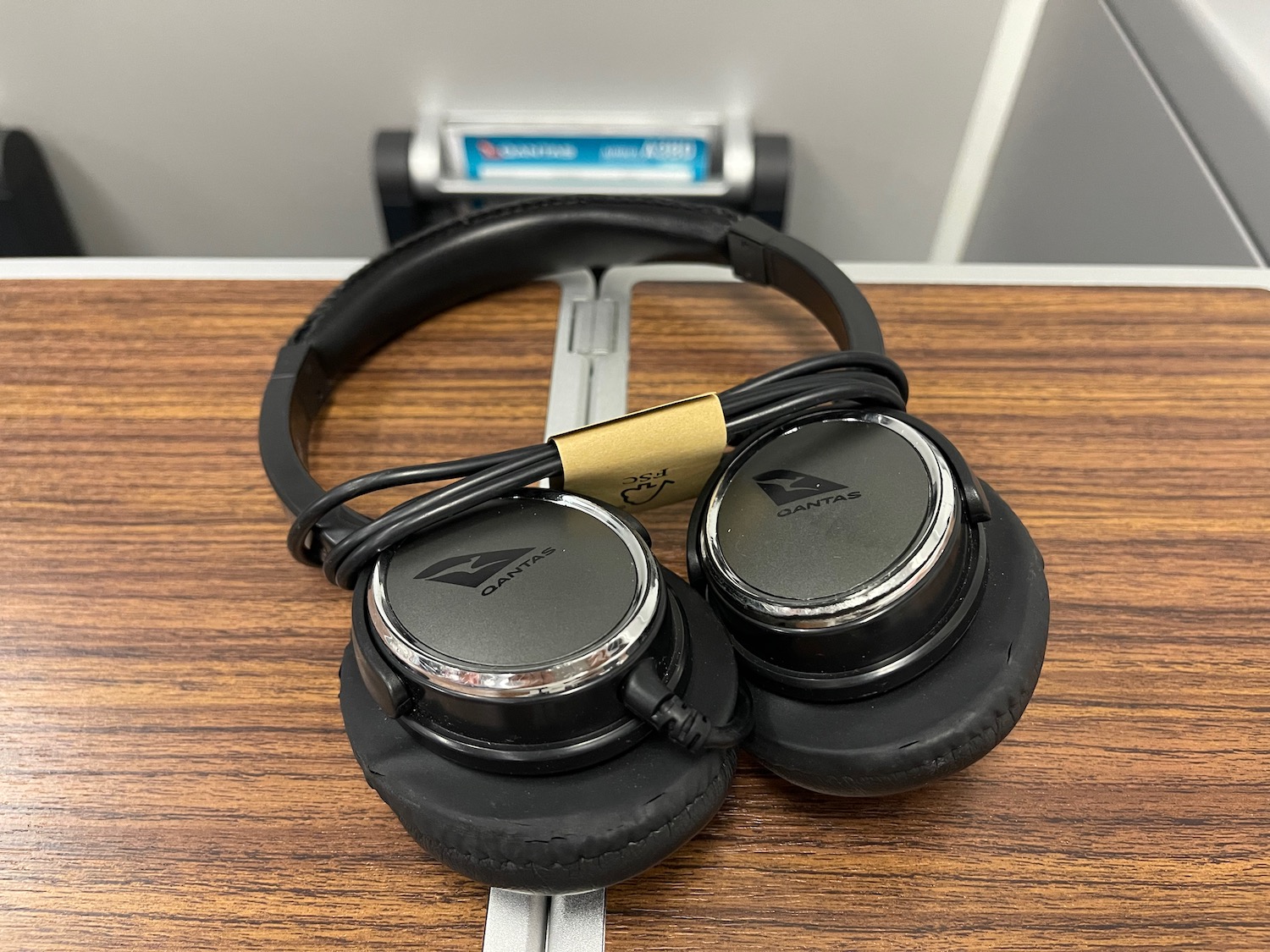 a pair of black headphones on a wood surface