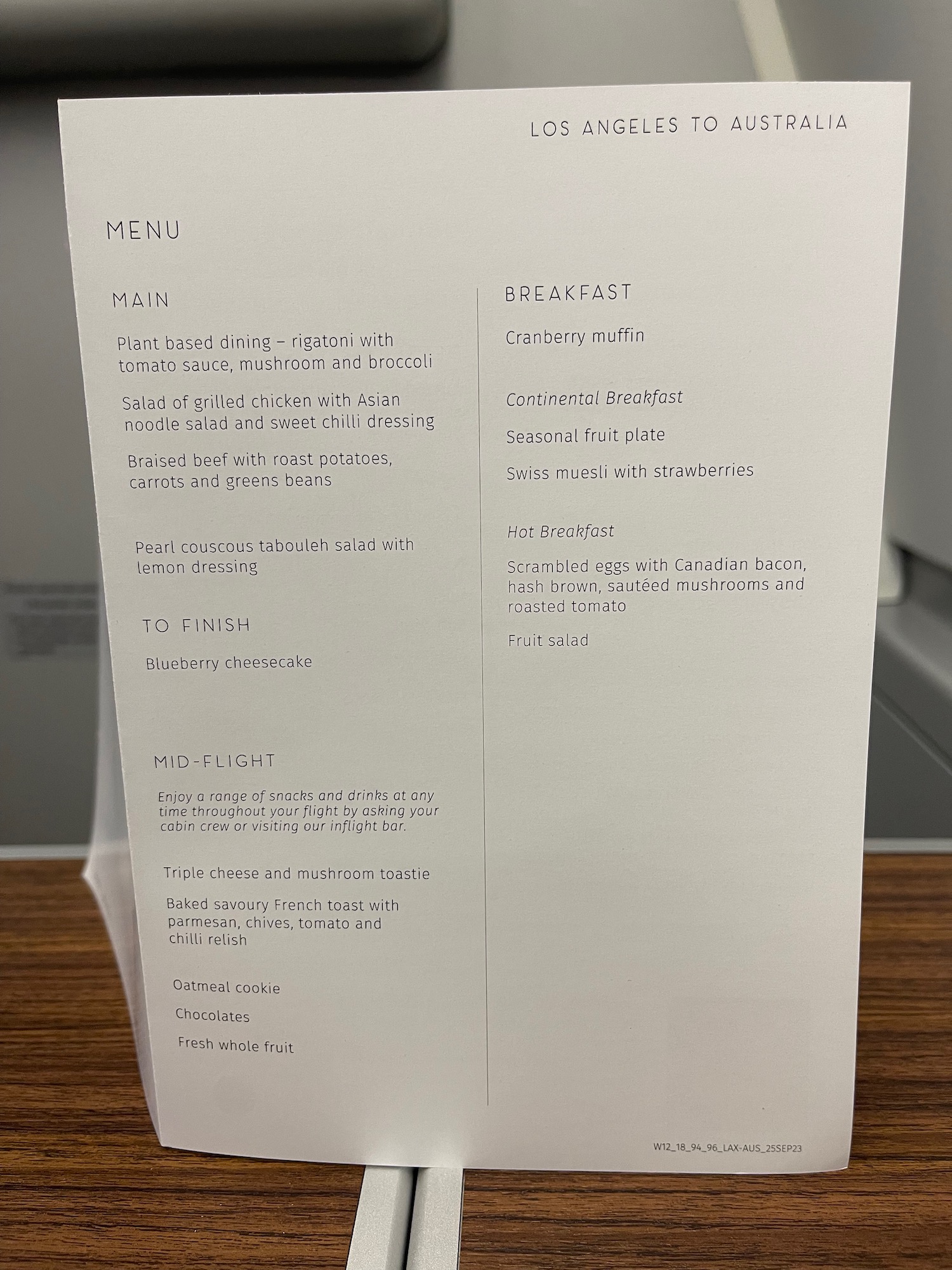 a white menu on a wood surface