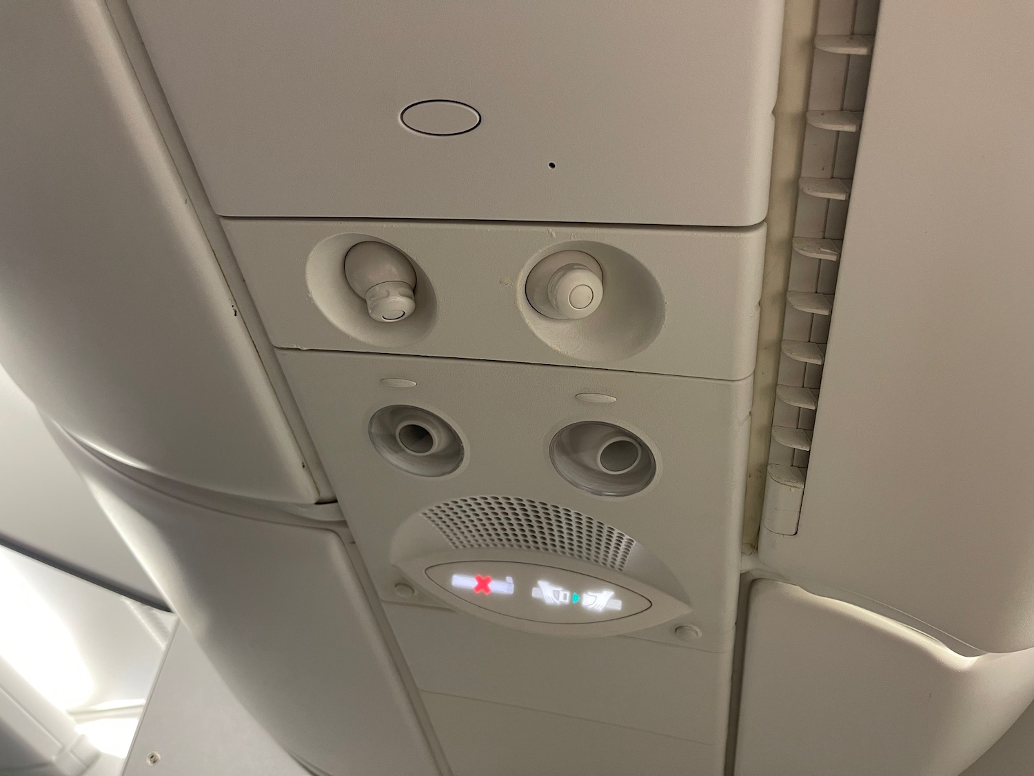 a white panel with buttons and a light on the ceiling