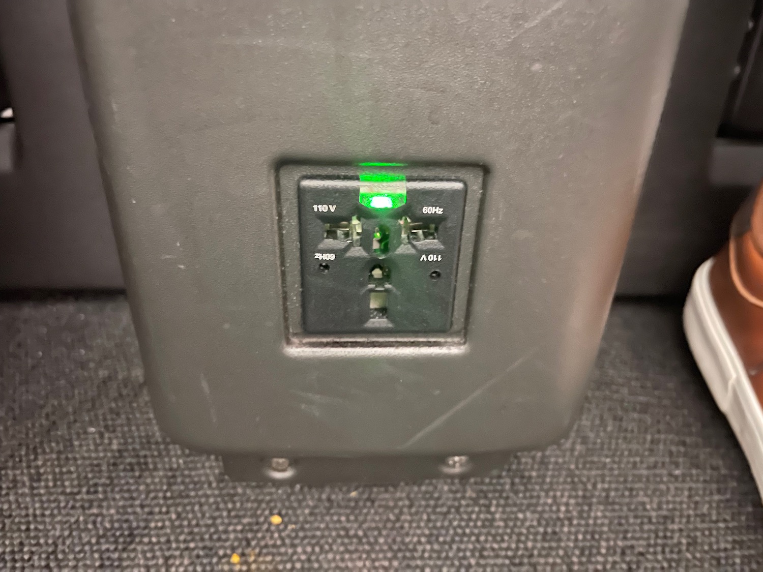 a black electrical outlet with green lights