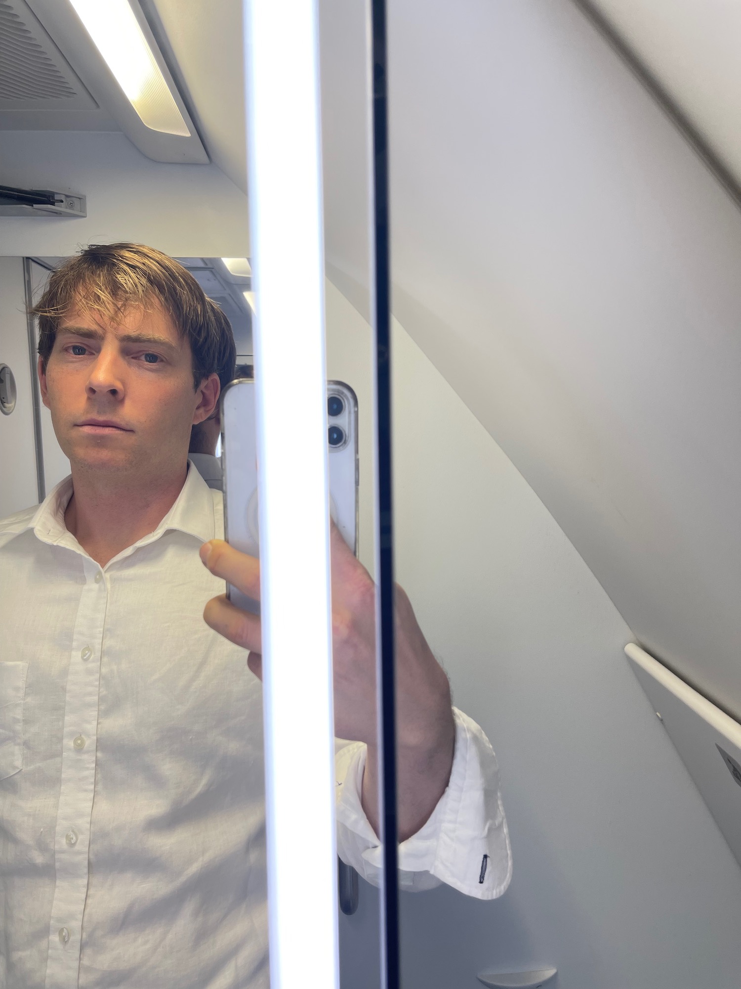 a man taking a selfie in a plane