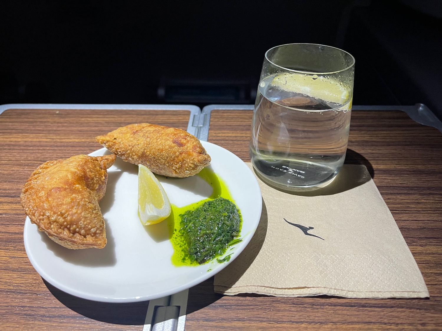 food on a plate next to a glass of water