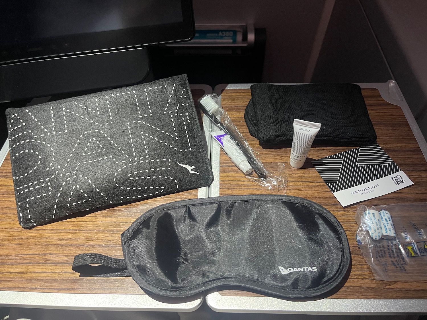 a black eye mask and other items on a table