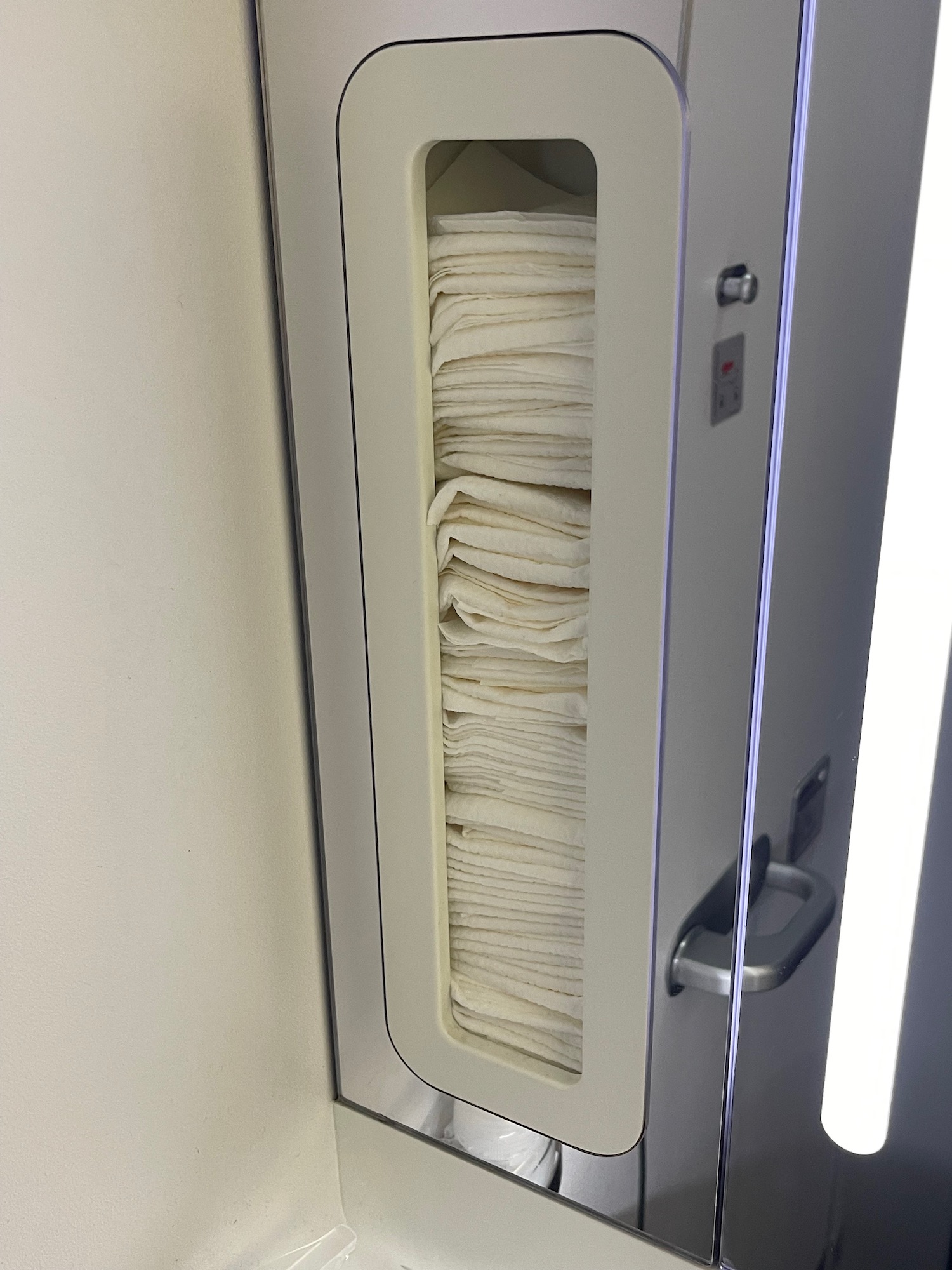 a stack of towels in a cabinet