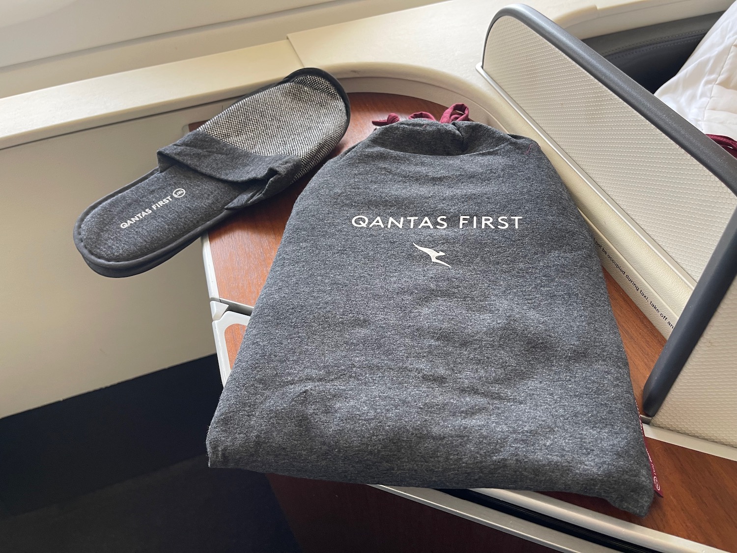 a grey shirt and slippers on a table