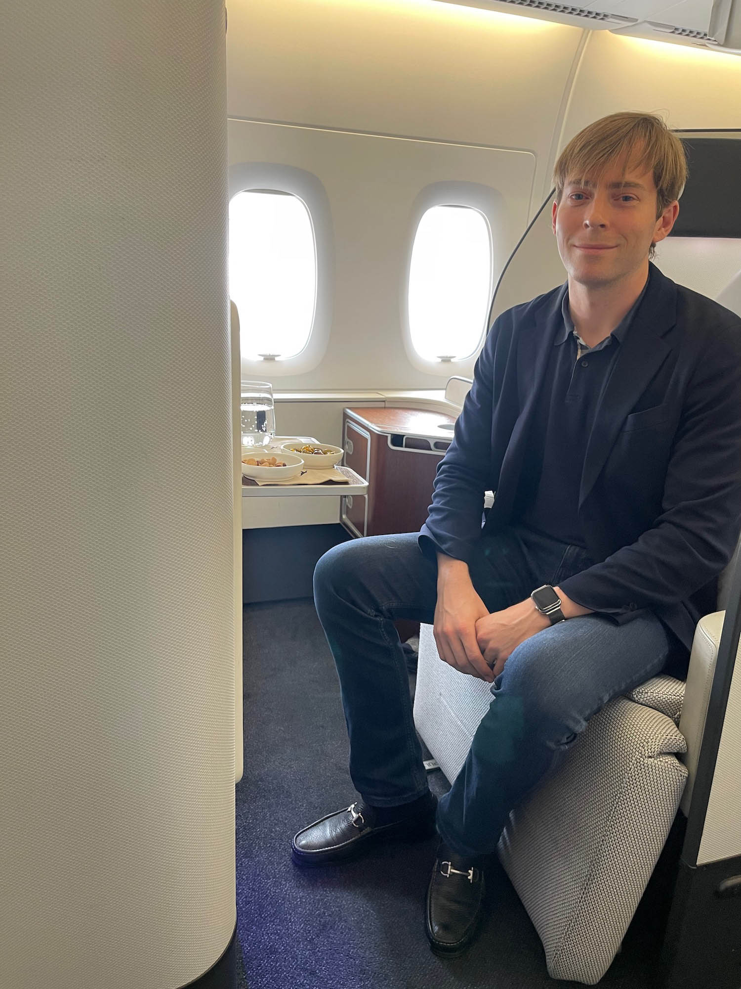 a man sitting on a chair in an airplane