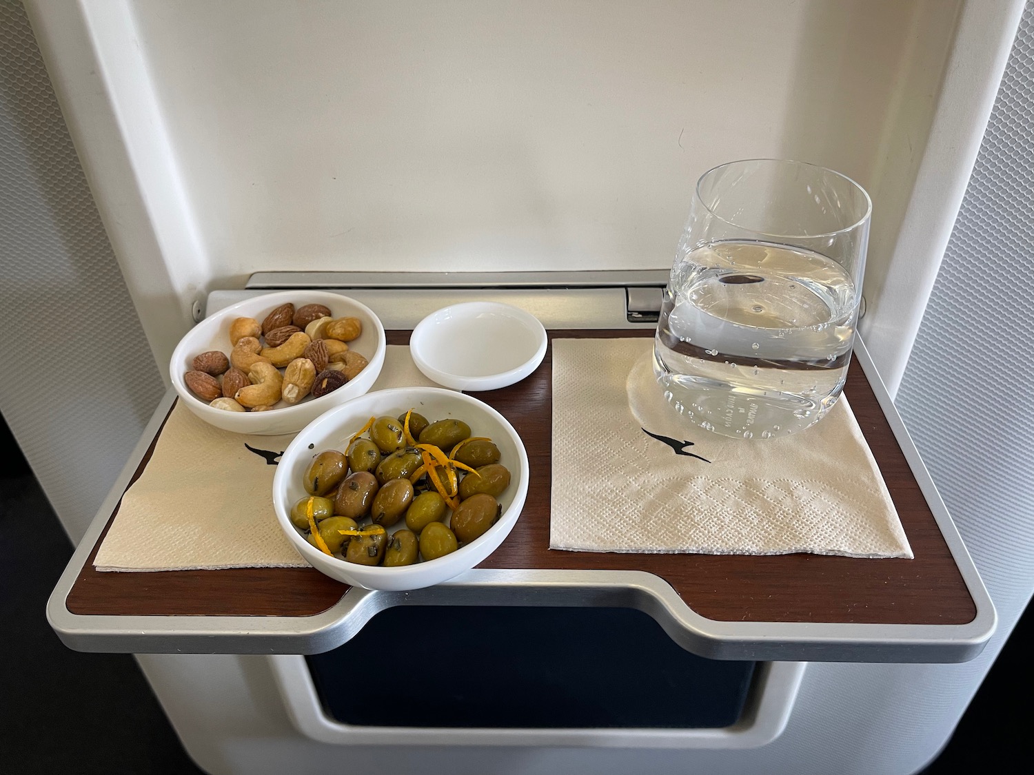 a tray with food and a glass of water on it