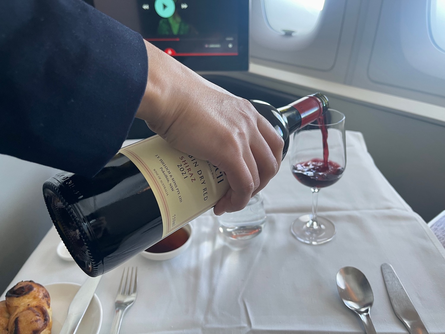 a person pouring wine into a glass