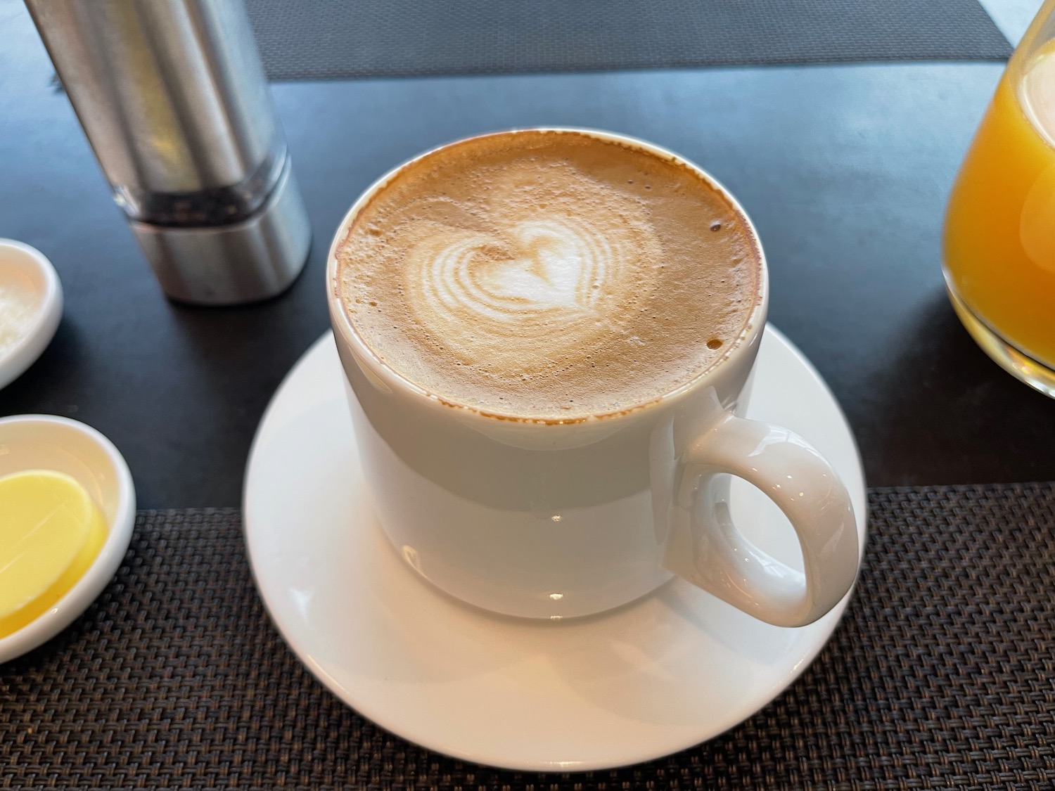 a cup of coffee with a heart shaped foam in the foam