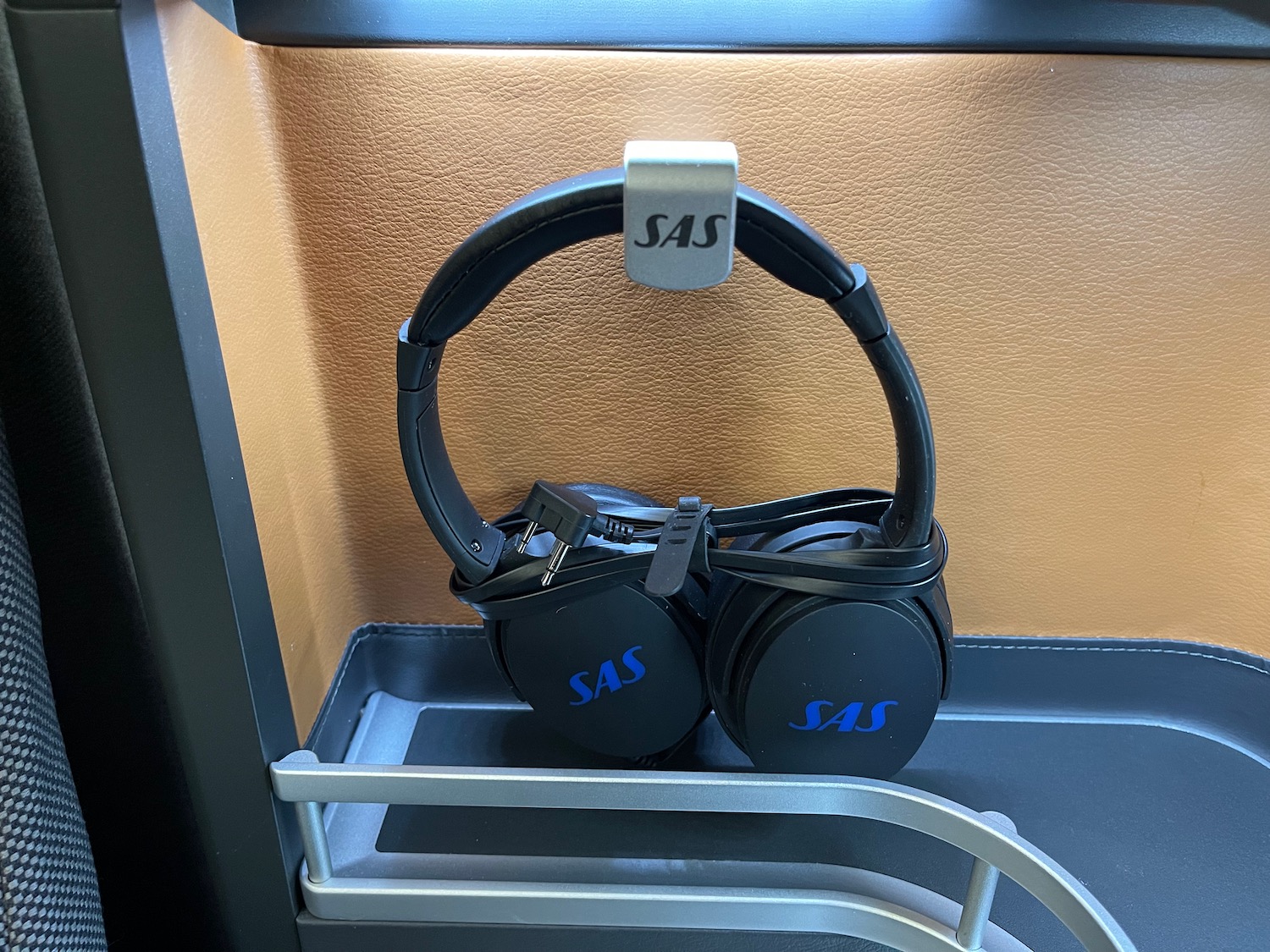 a pair of black headphones on a metal shelf